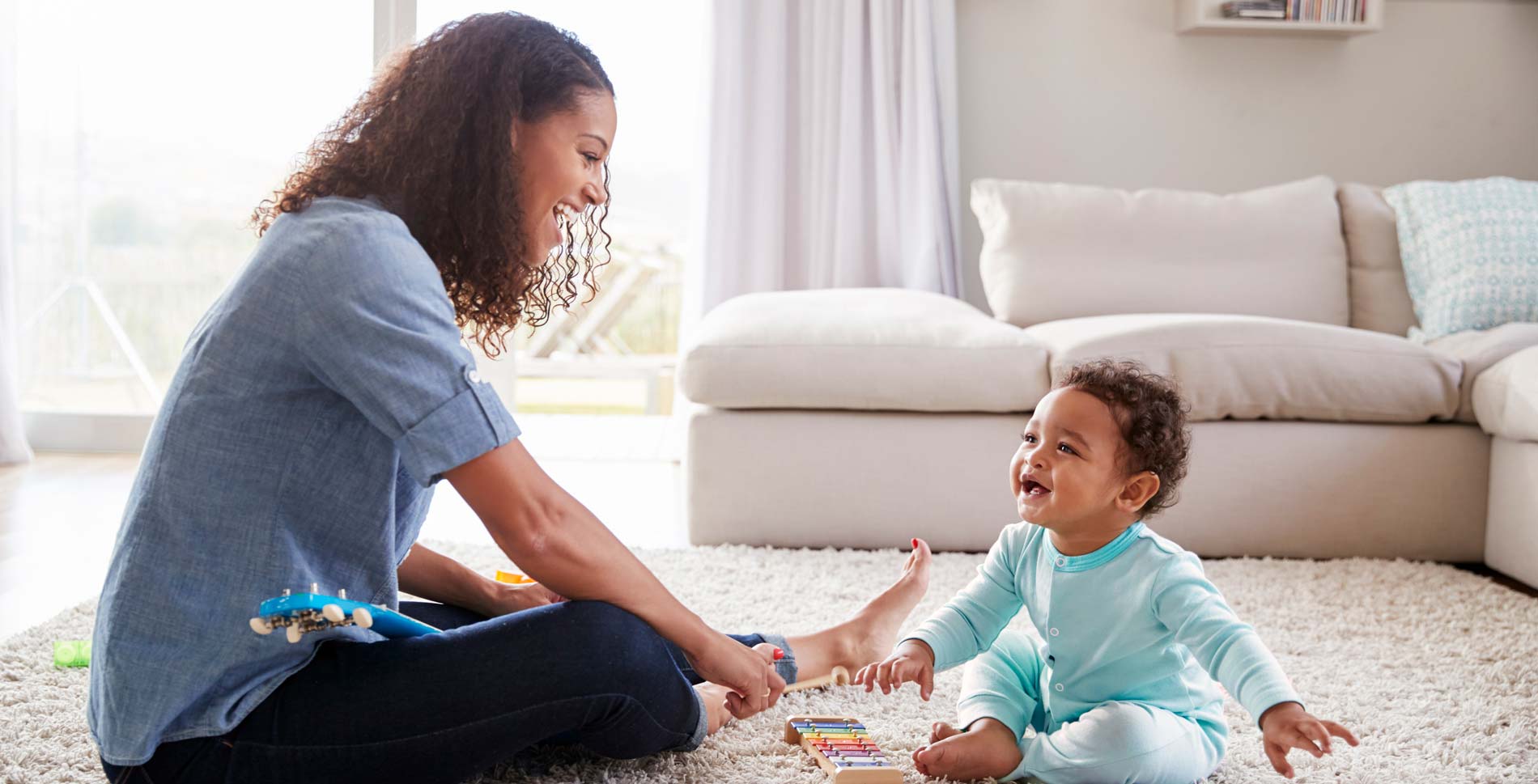 a person and a child playing with toys on the floor