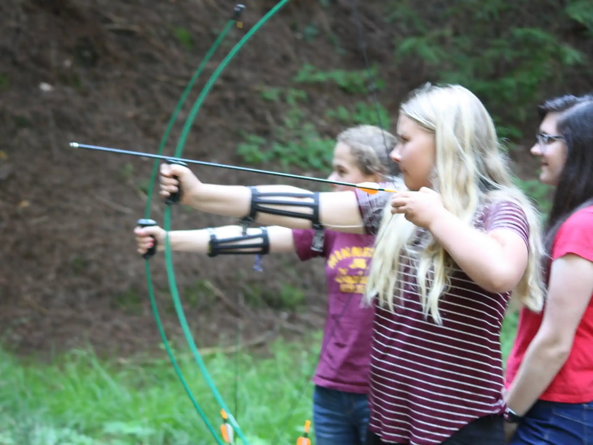 a group of people holding a bow and arrow