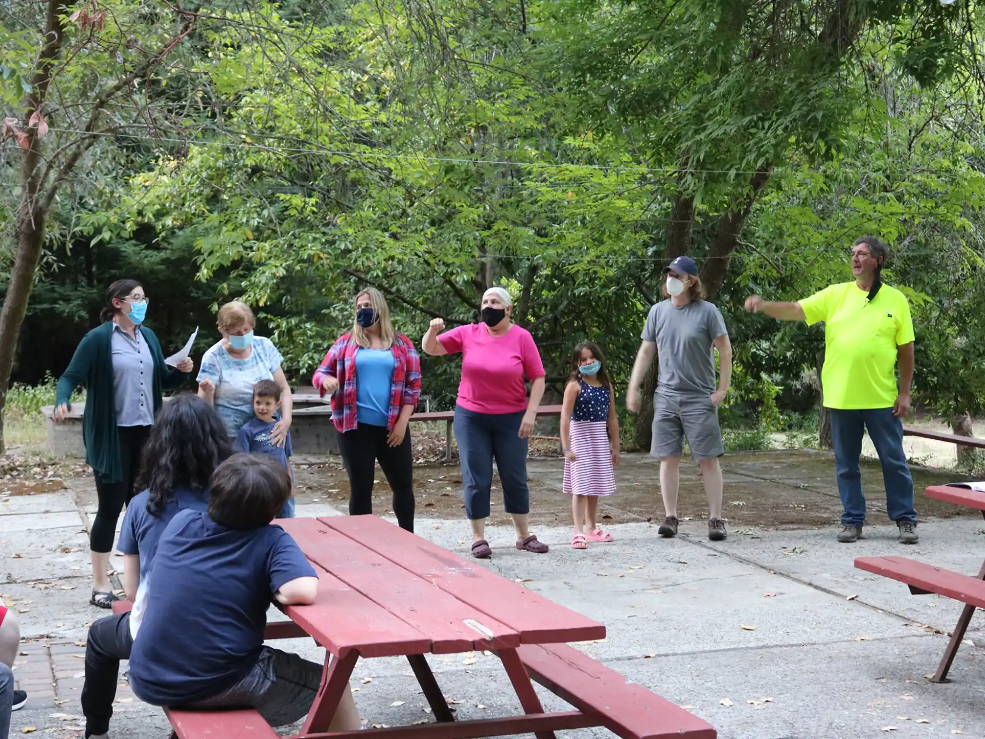 a group of people standing around a table outside