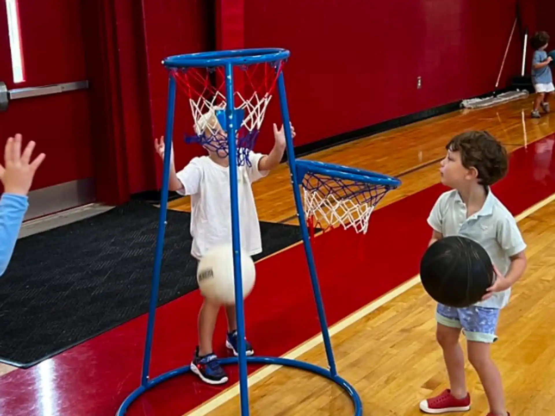 a group of kids playing basketball
