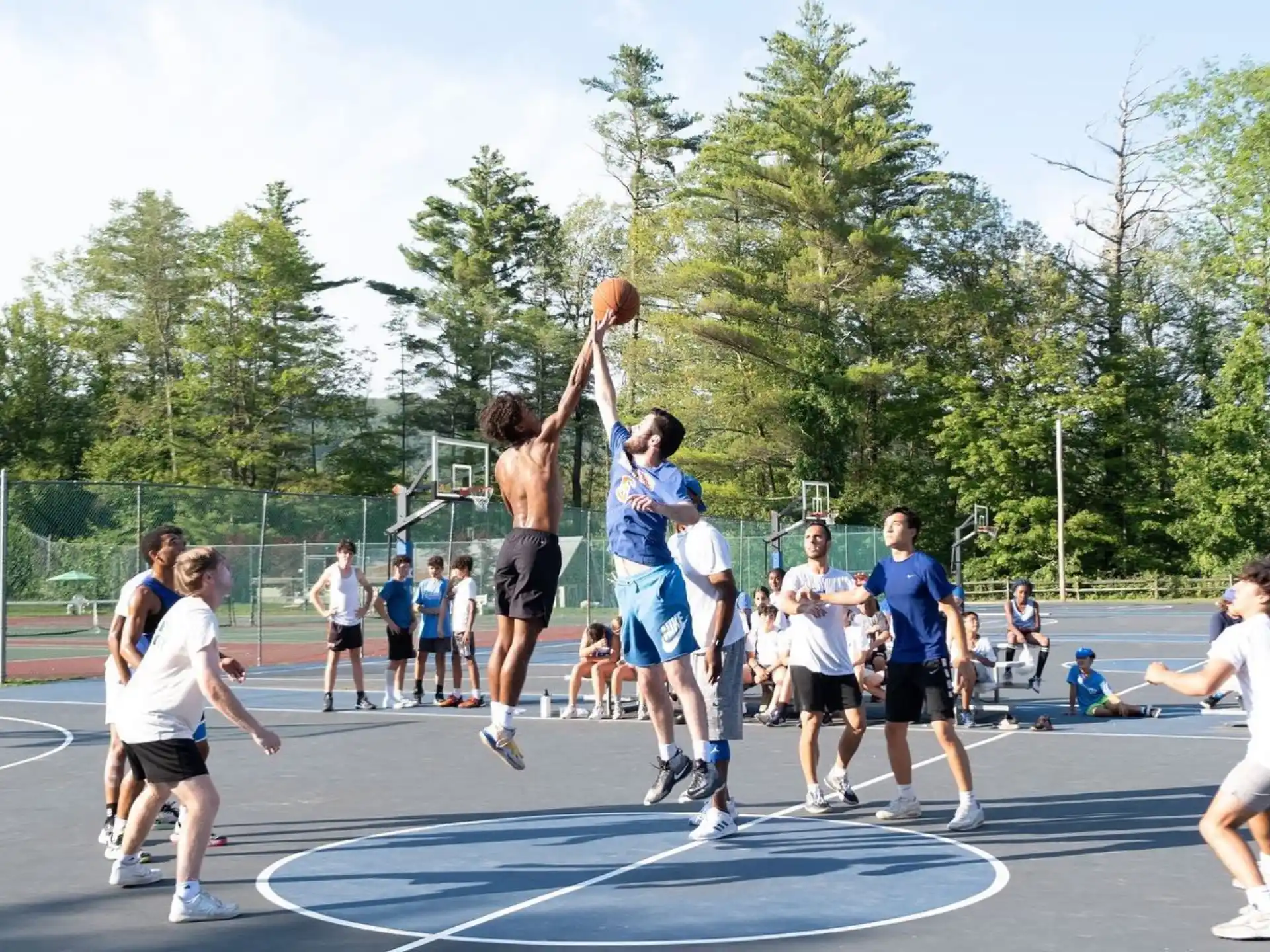 a group of people playing basketball