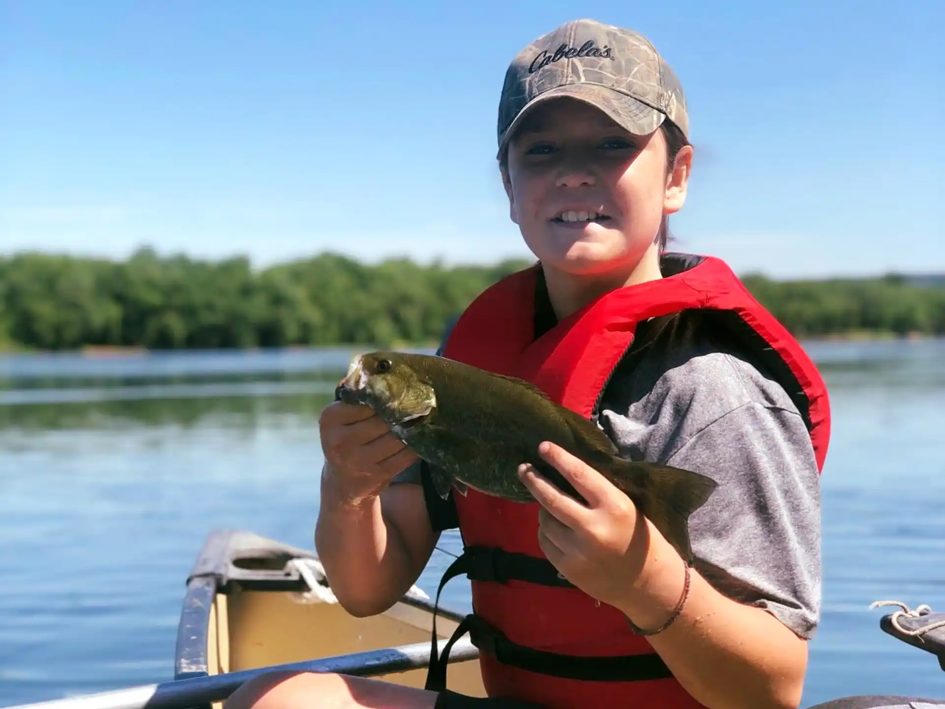 a boy holding a fish