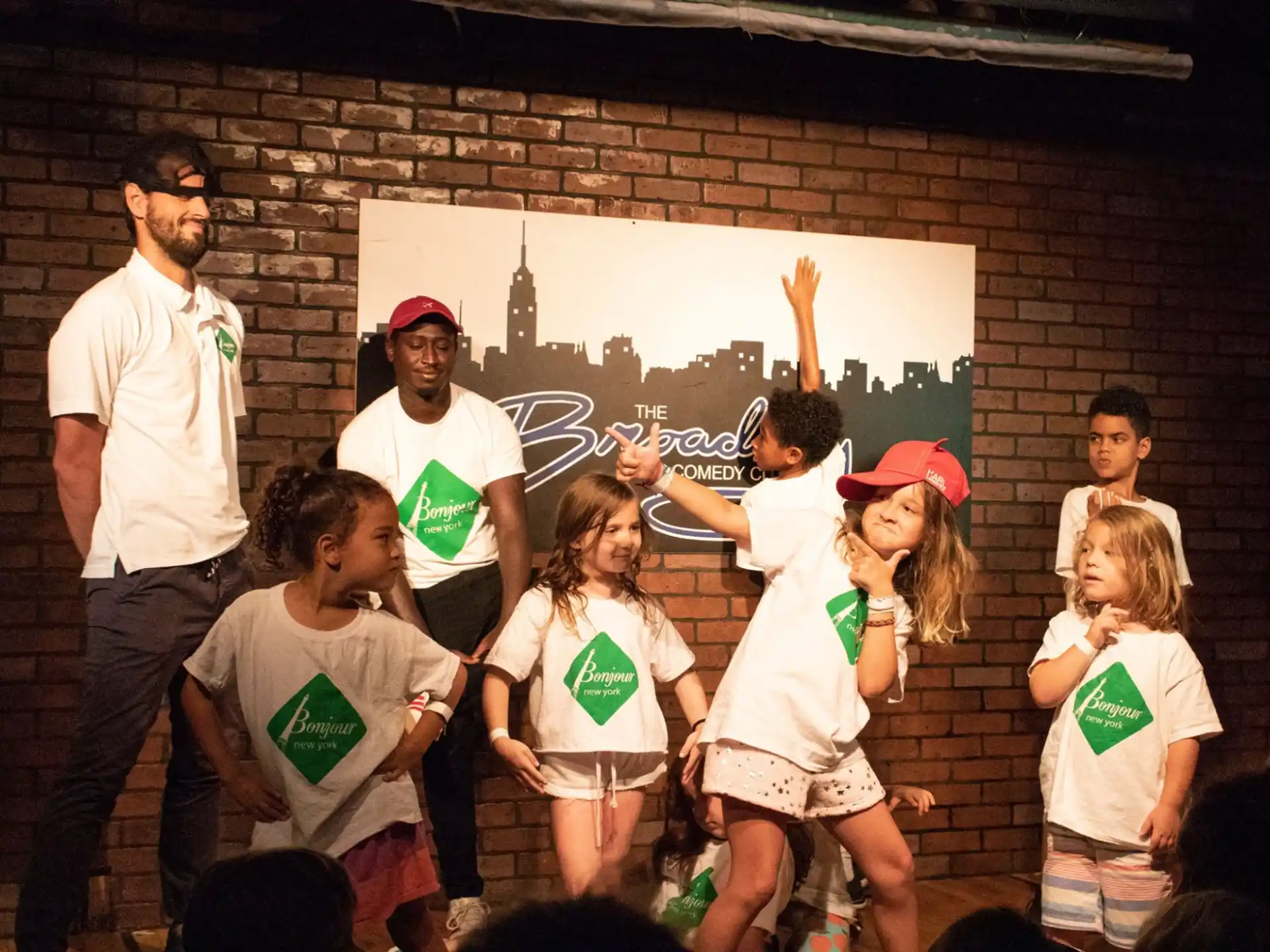 a group of people standing in front of a brick wall