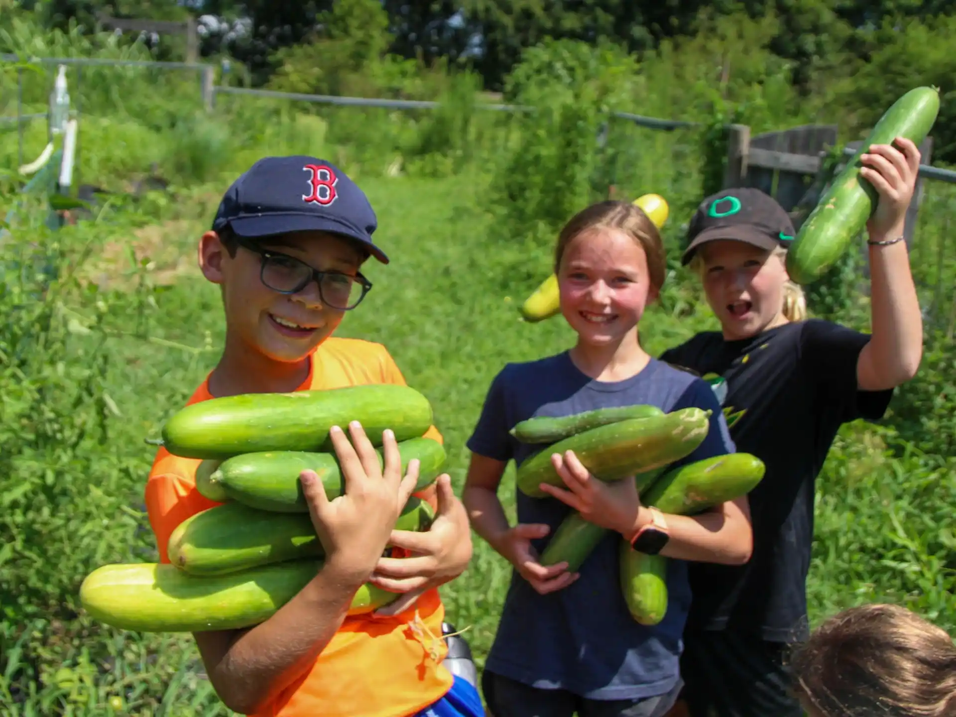 a group of kids holding watermelons