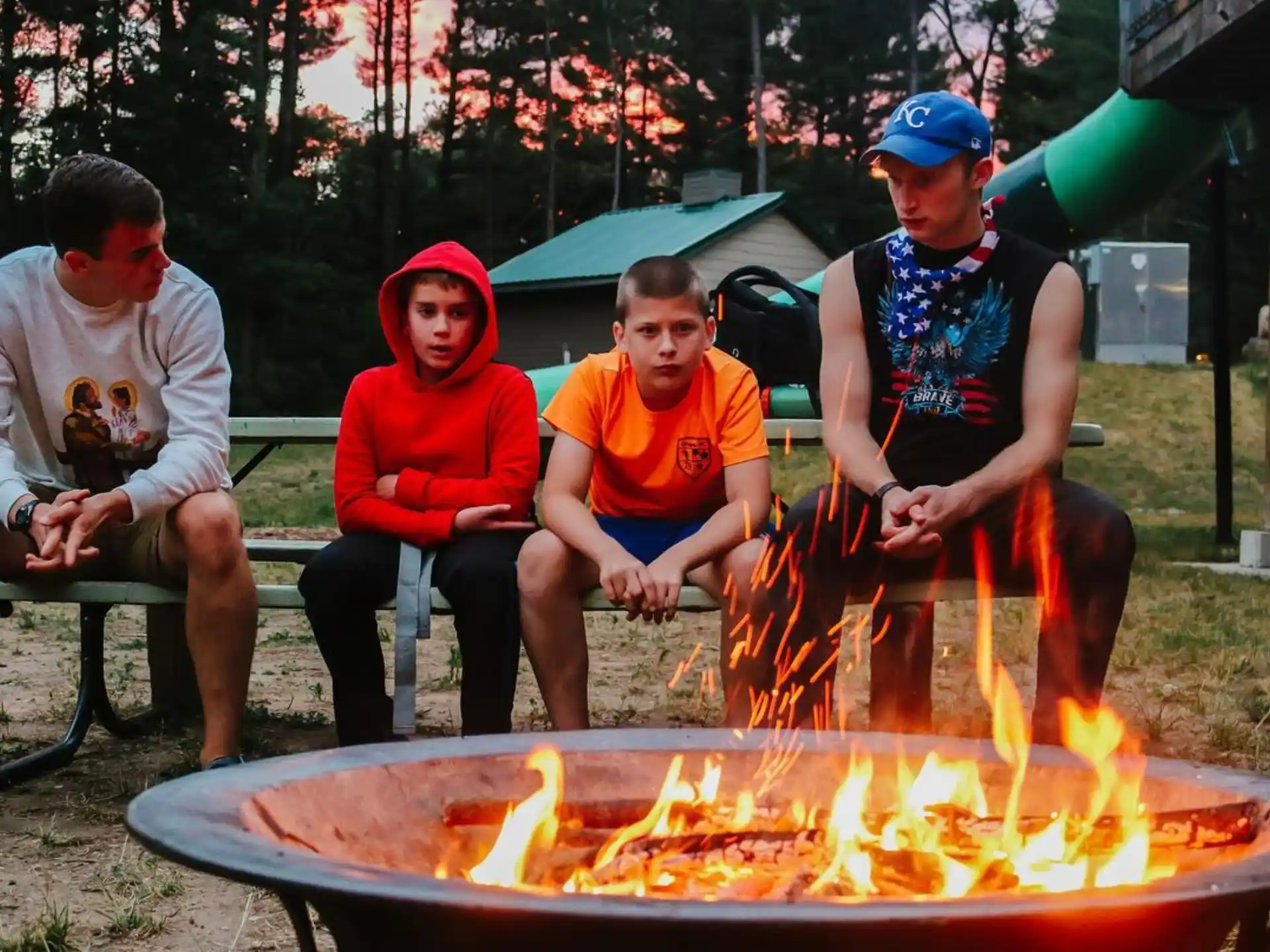 a group of people sitting around a fire pit