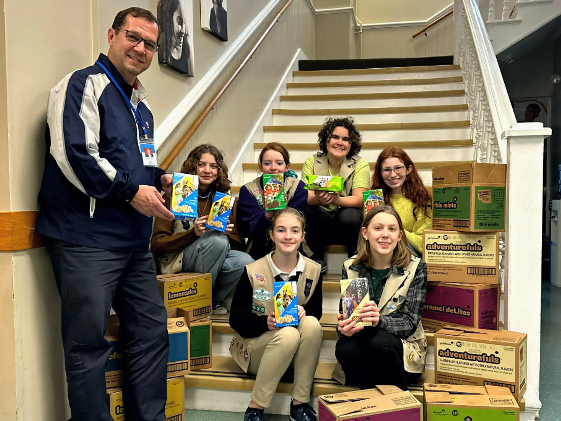 a person standing in front of a group of people sitting on stairs