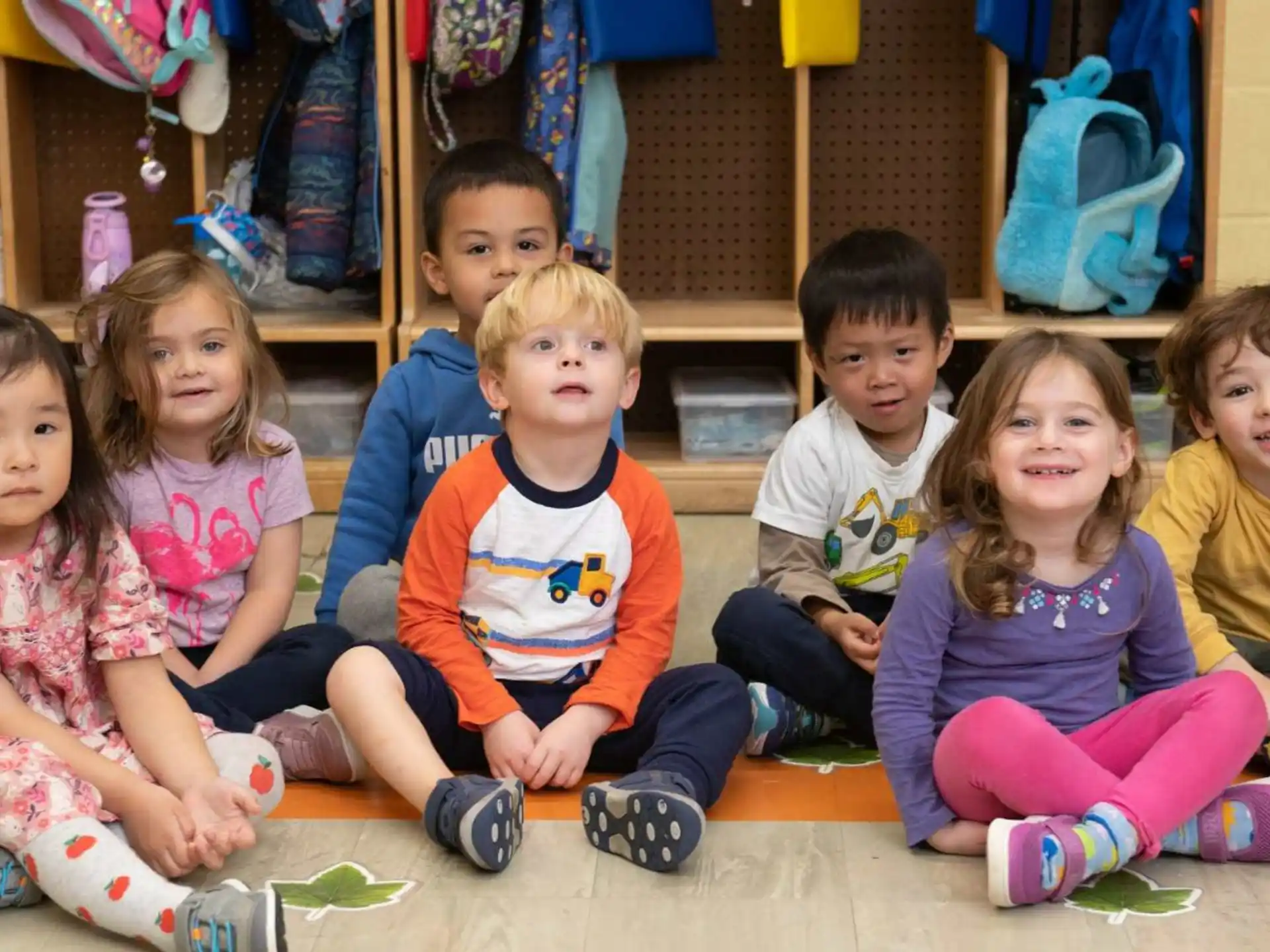 a group of children sitting on the floor