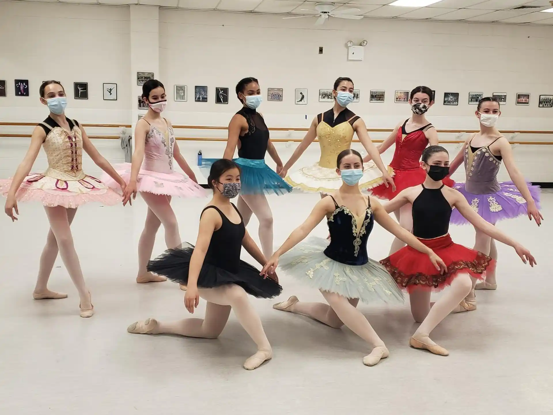 a group of women wearing dresses and dancing