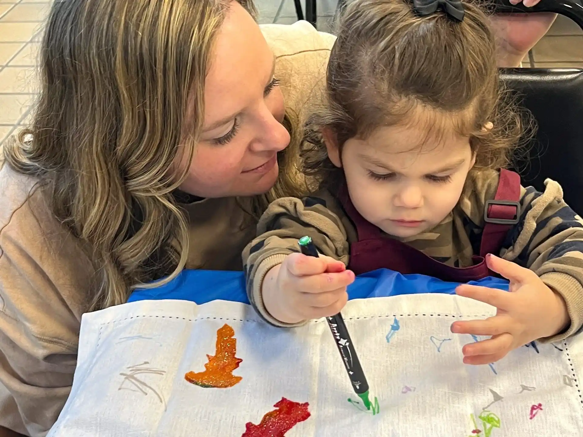 a person and a child painting