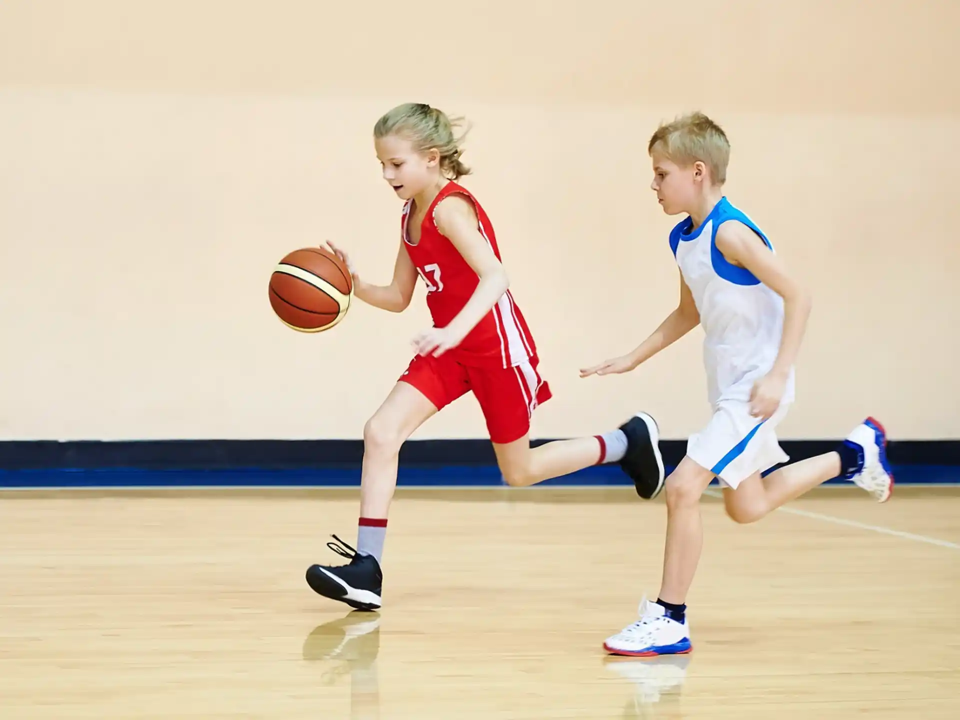 a couple of kids playing basketball