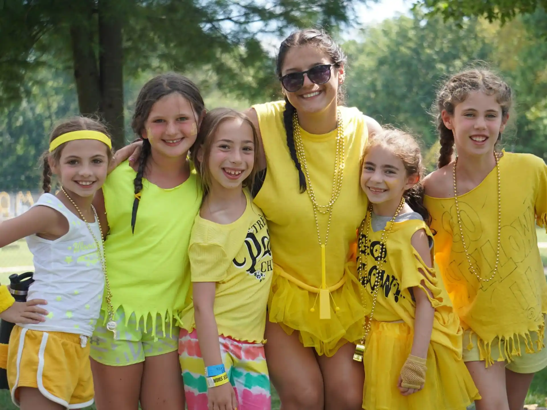 a group of women in matching yellow shirts