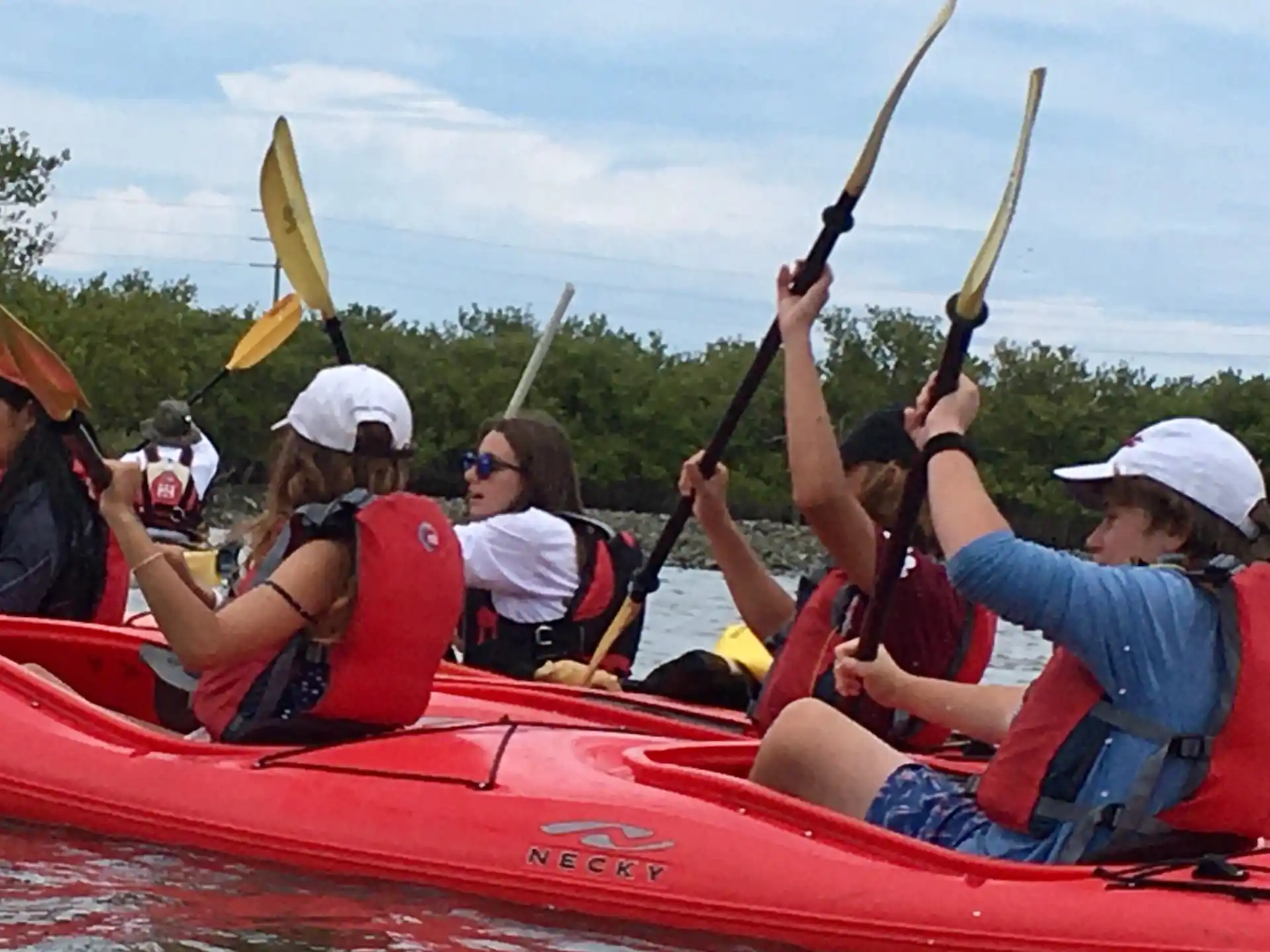 a group of people in a canoe