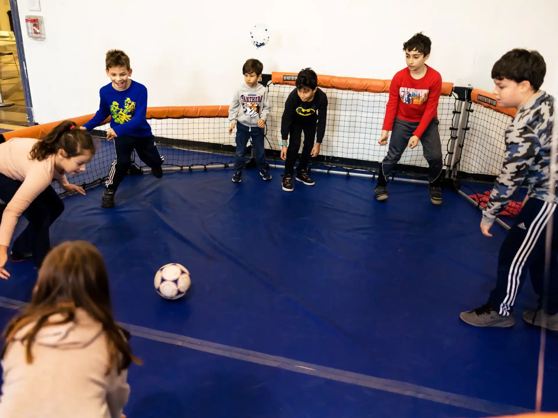 a group of kids playing football