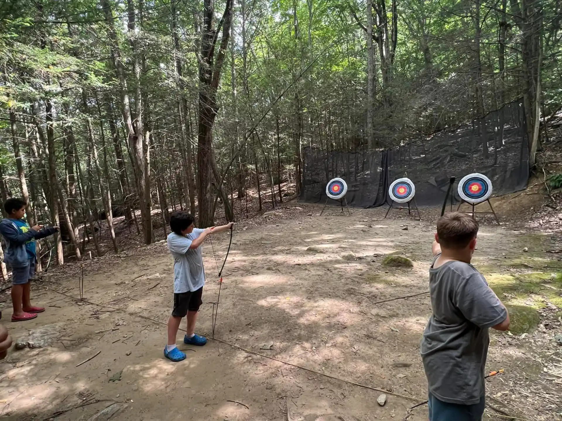 a group of kids playing in the woods