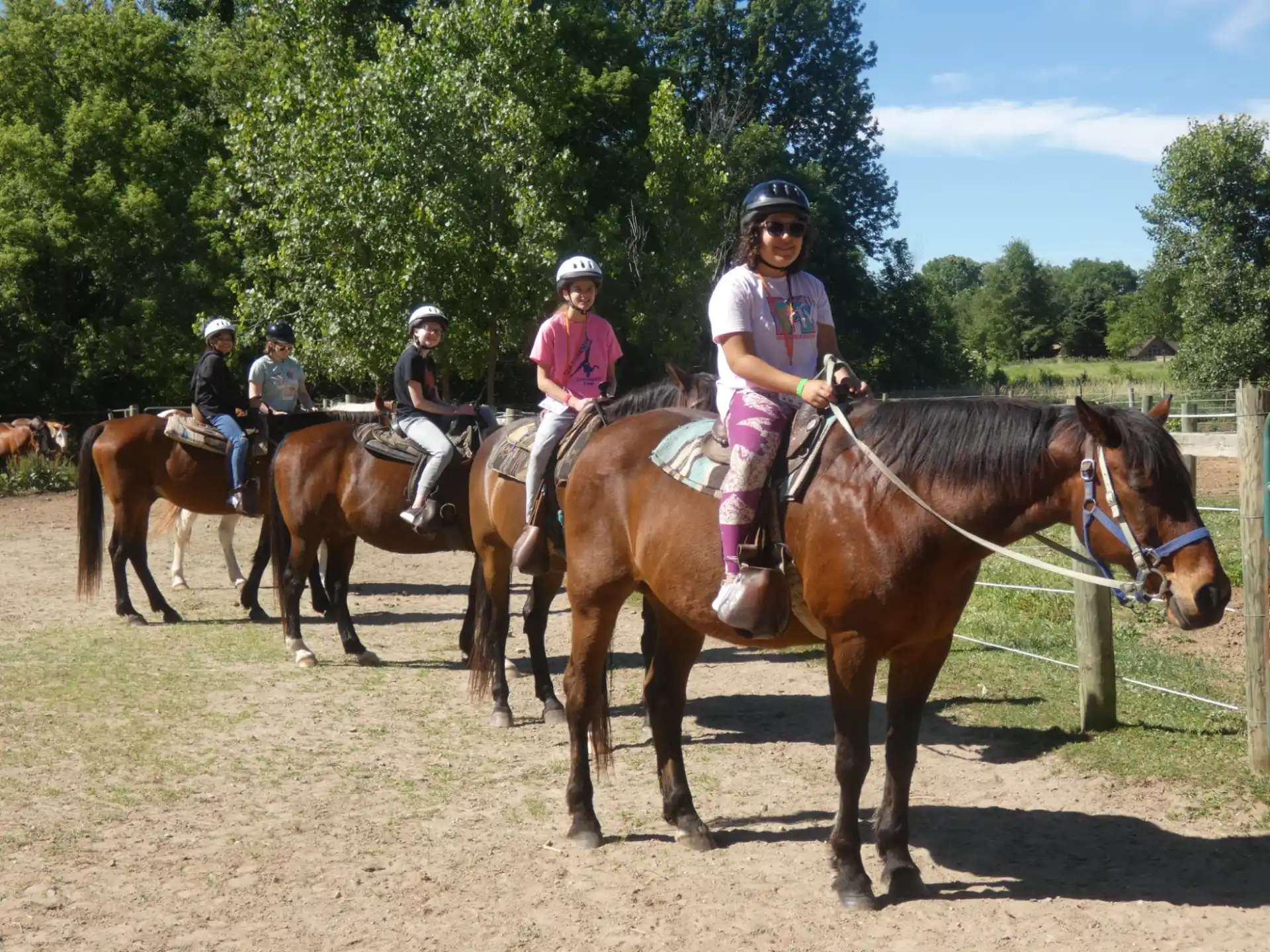 a group of people riding horses