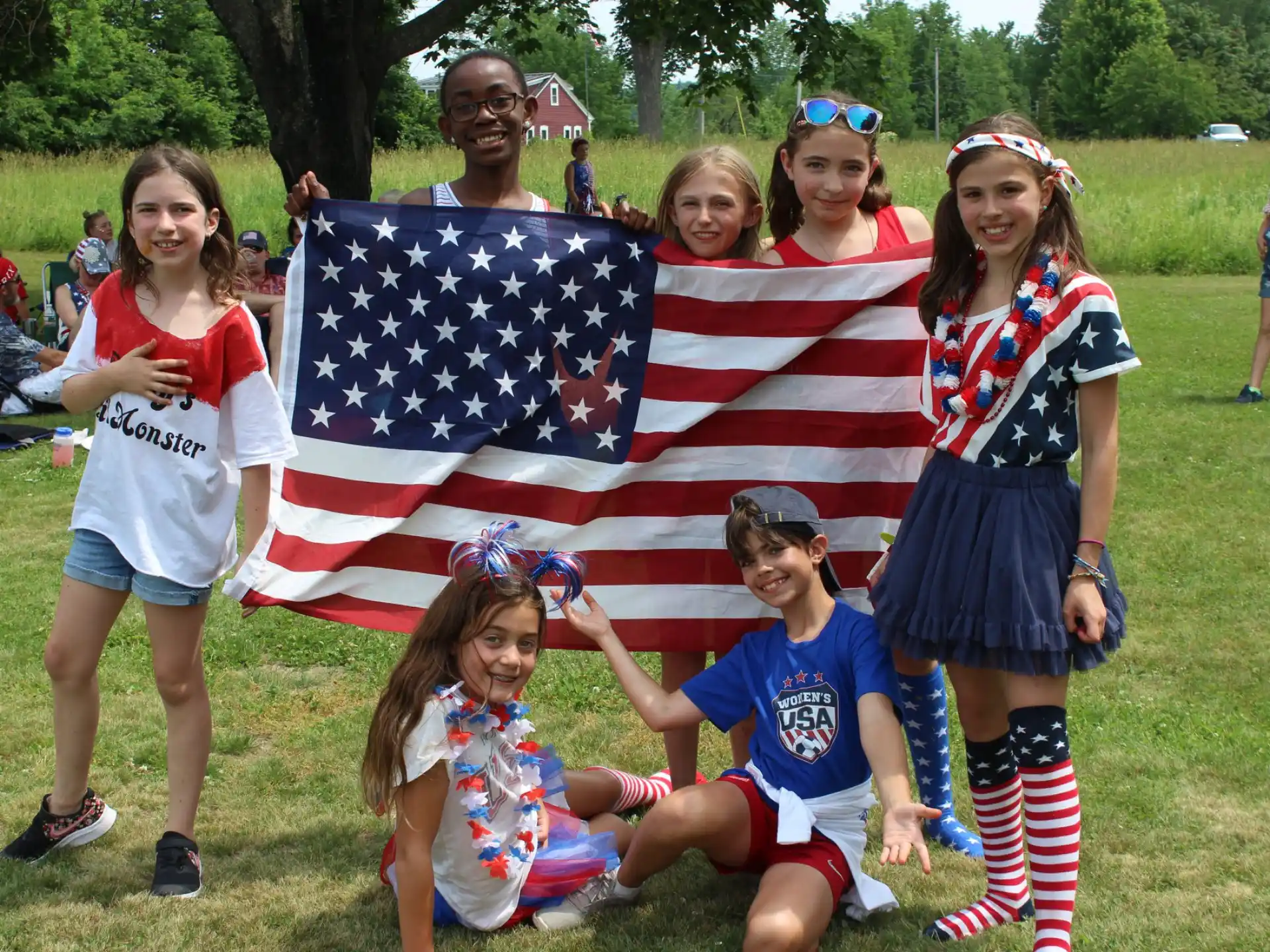 a group of people posing for a photo with a flag