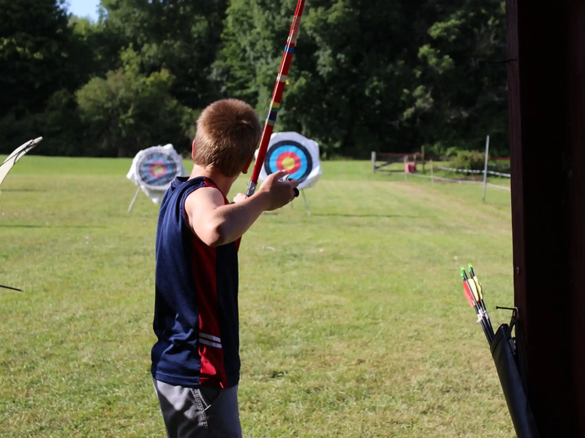 a boy holding a bow and arrow