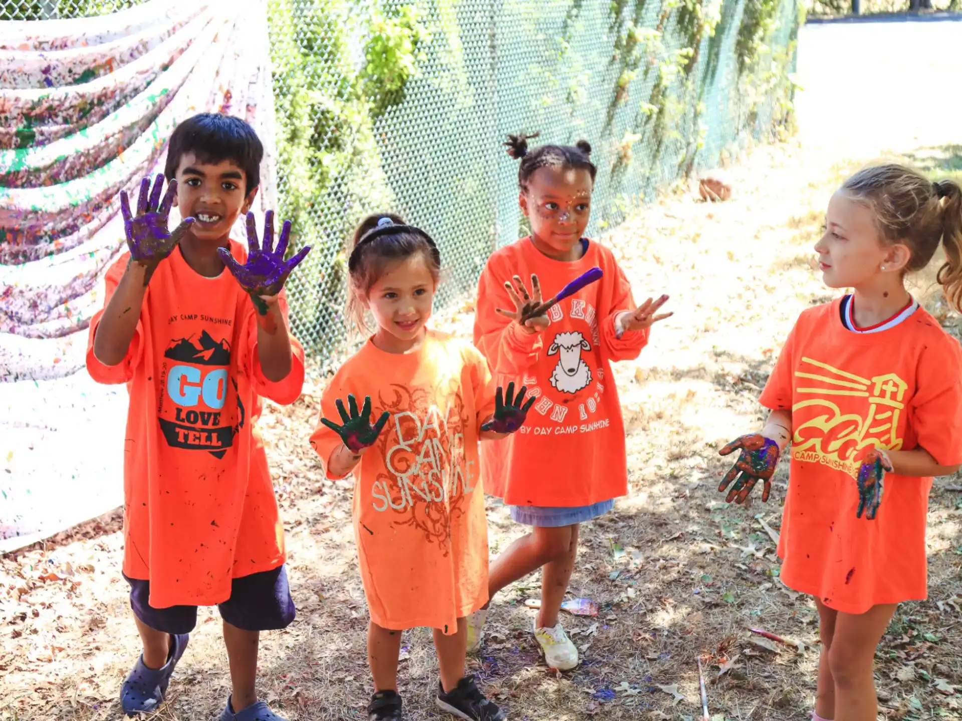 a group of children wearing matching t-shirts and running