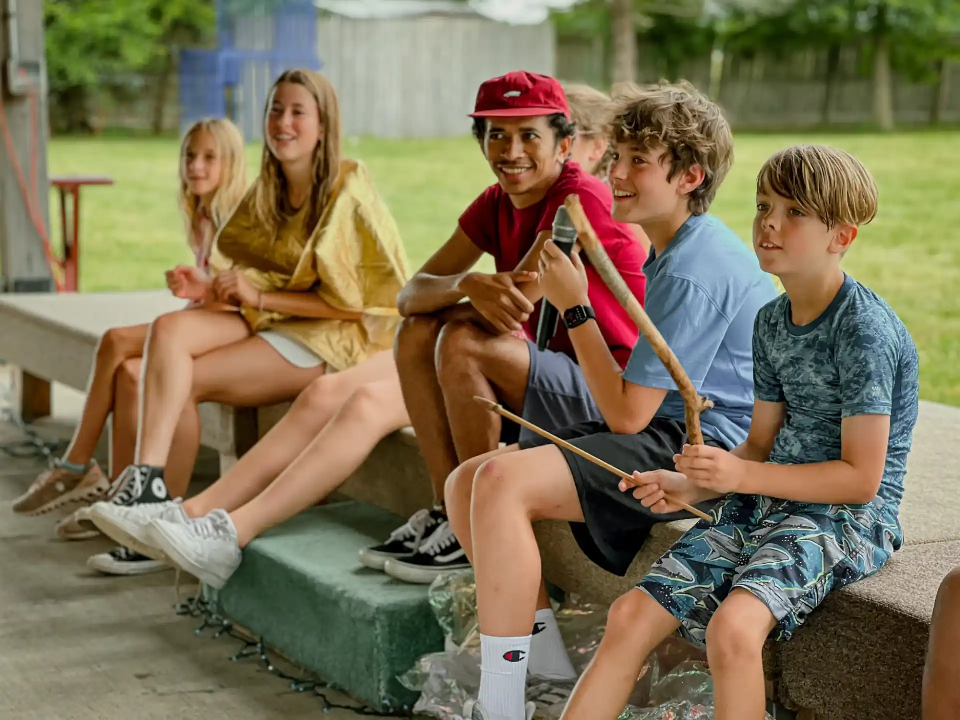 a group of people sitting on a bench playing instruments