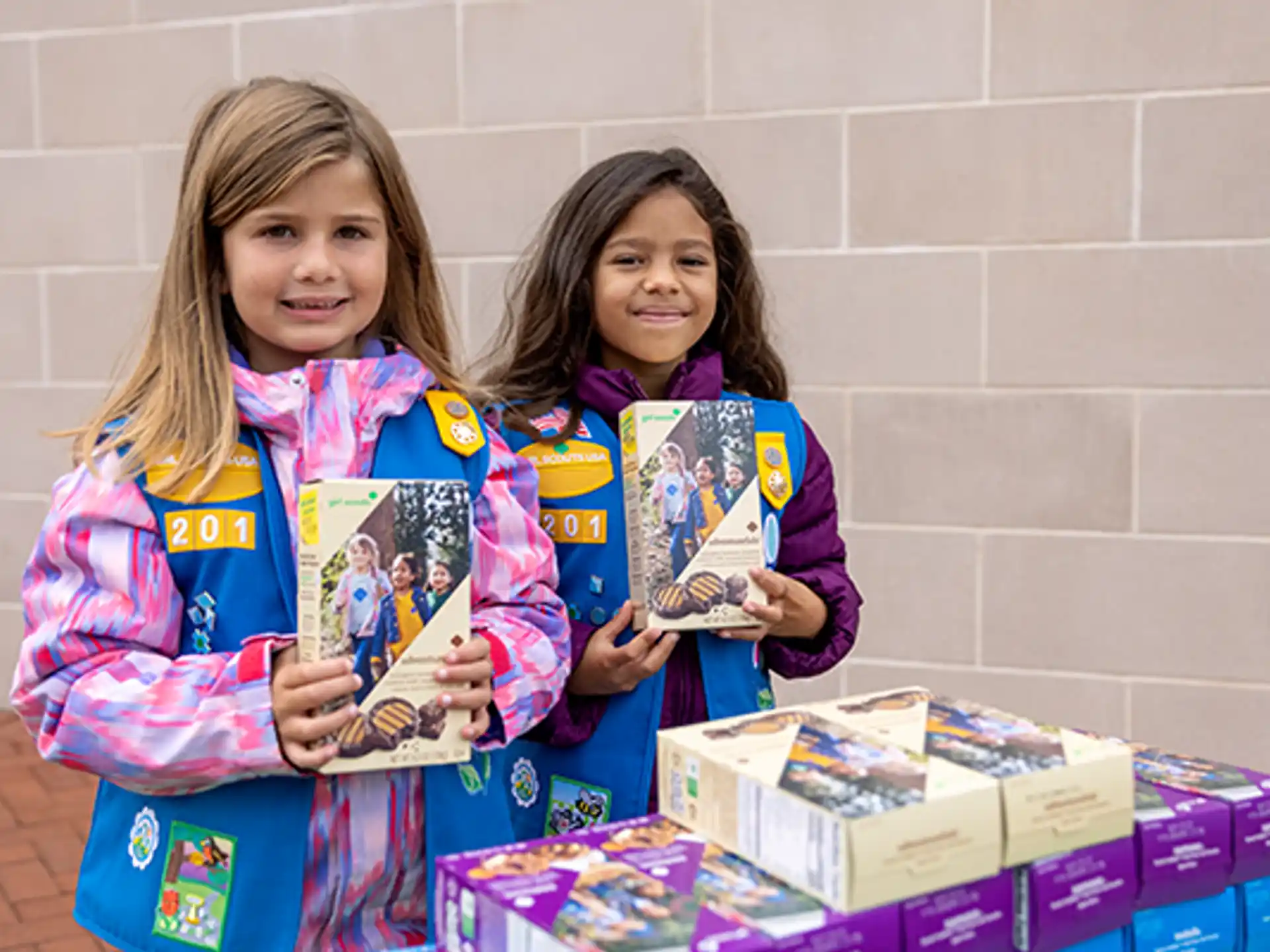 a couple of girls holding books