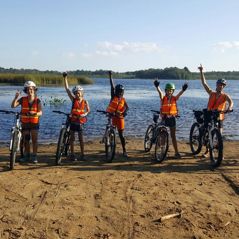 a group of people on bicycles posing for the camera