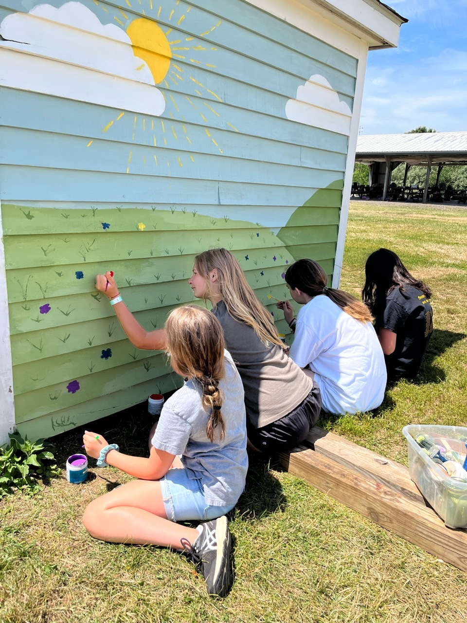 a group of people painting a house
