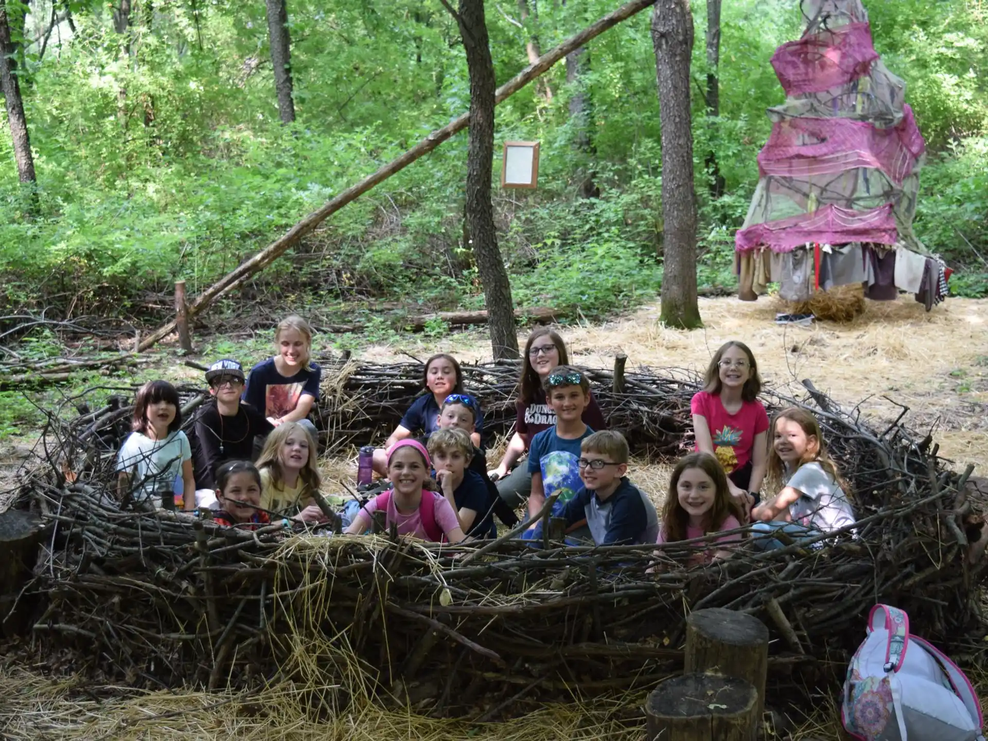 a group of people posing for a photo in the woods