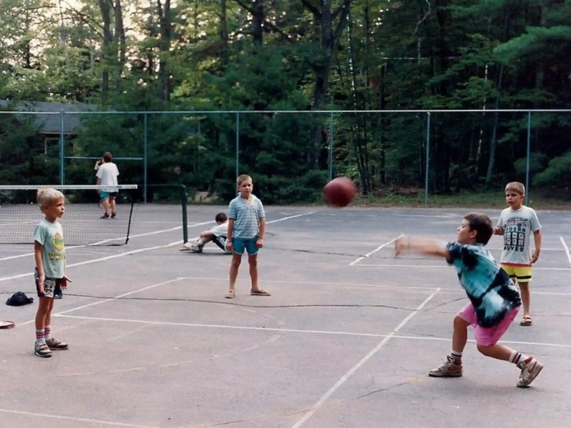 a group of kids playing basketball