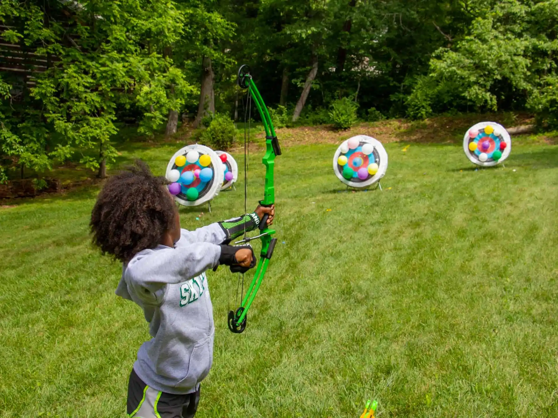 a boy holding a bow and arrow