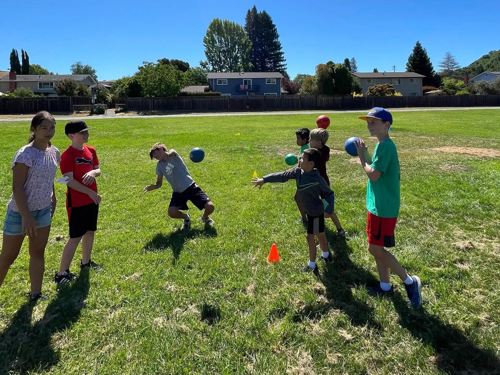 a group of kids playing with balls