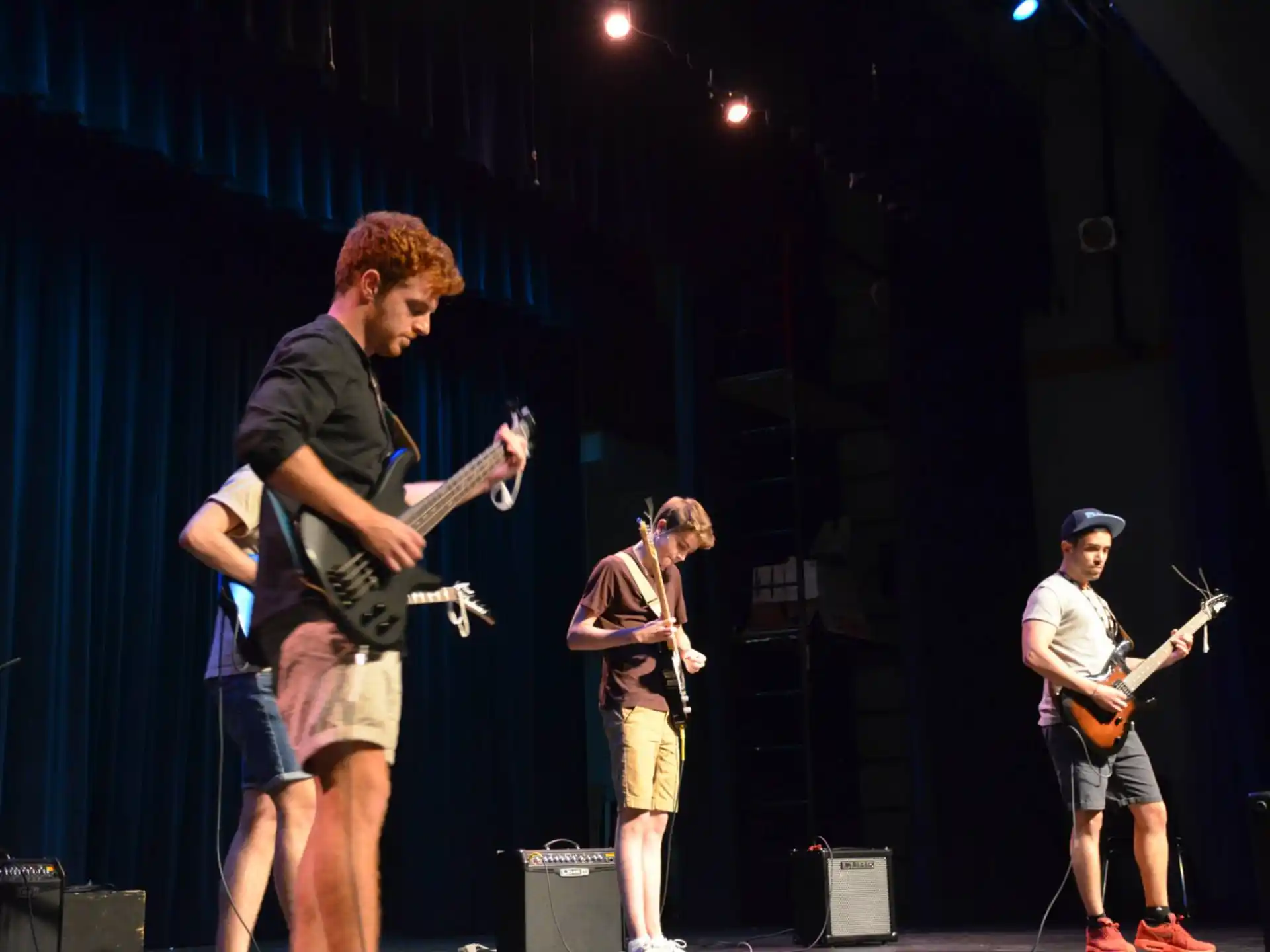 a group of people playing instruments on a stage