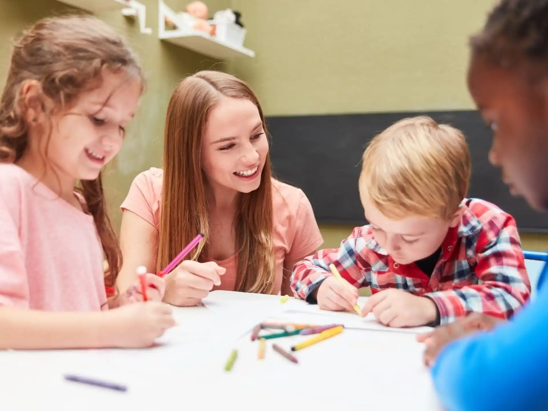 a group of children sitting at a table