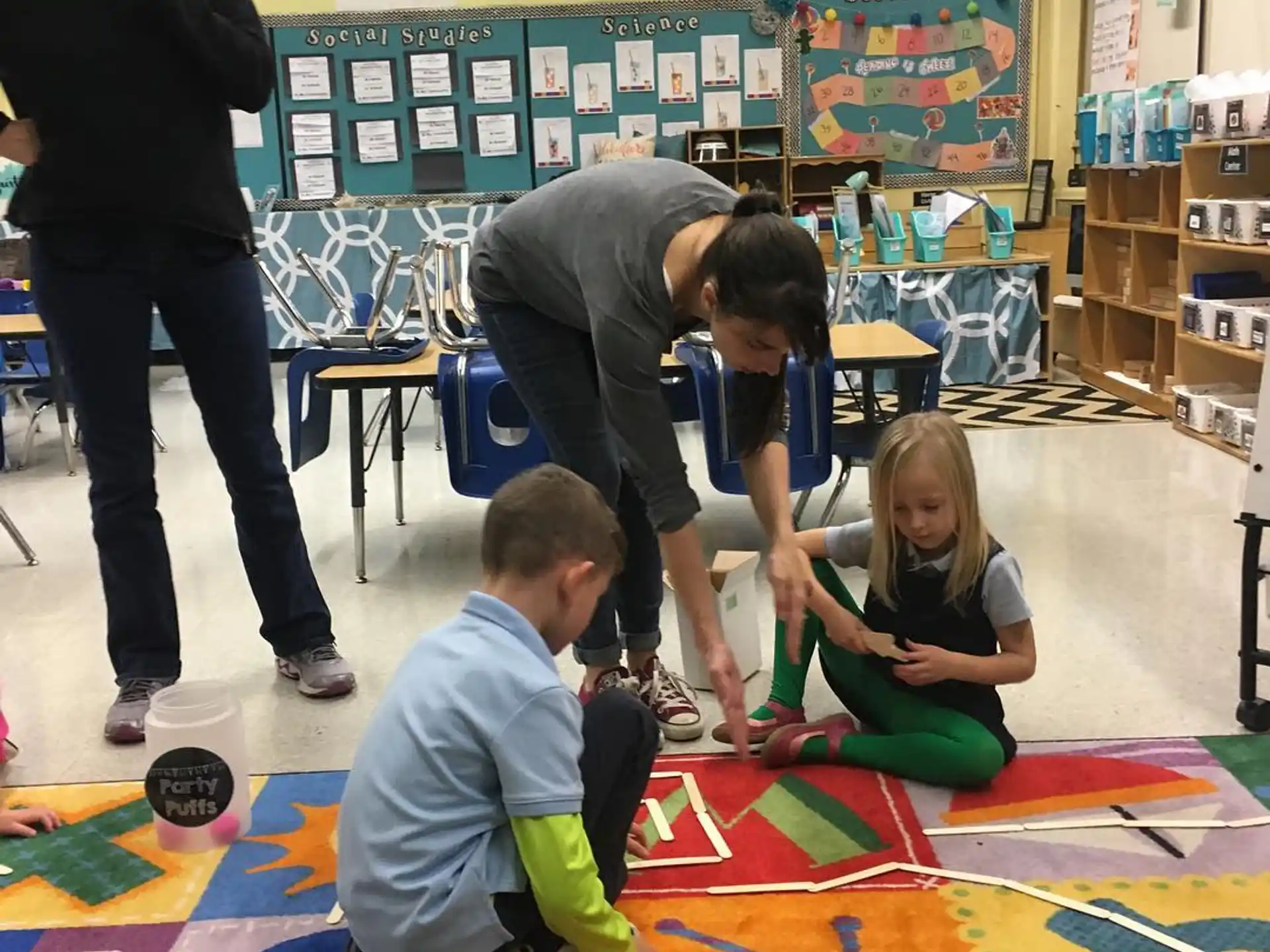 a group of children sitting on the floor in a classroom