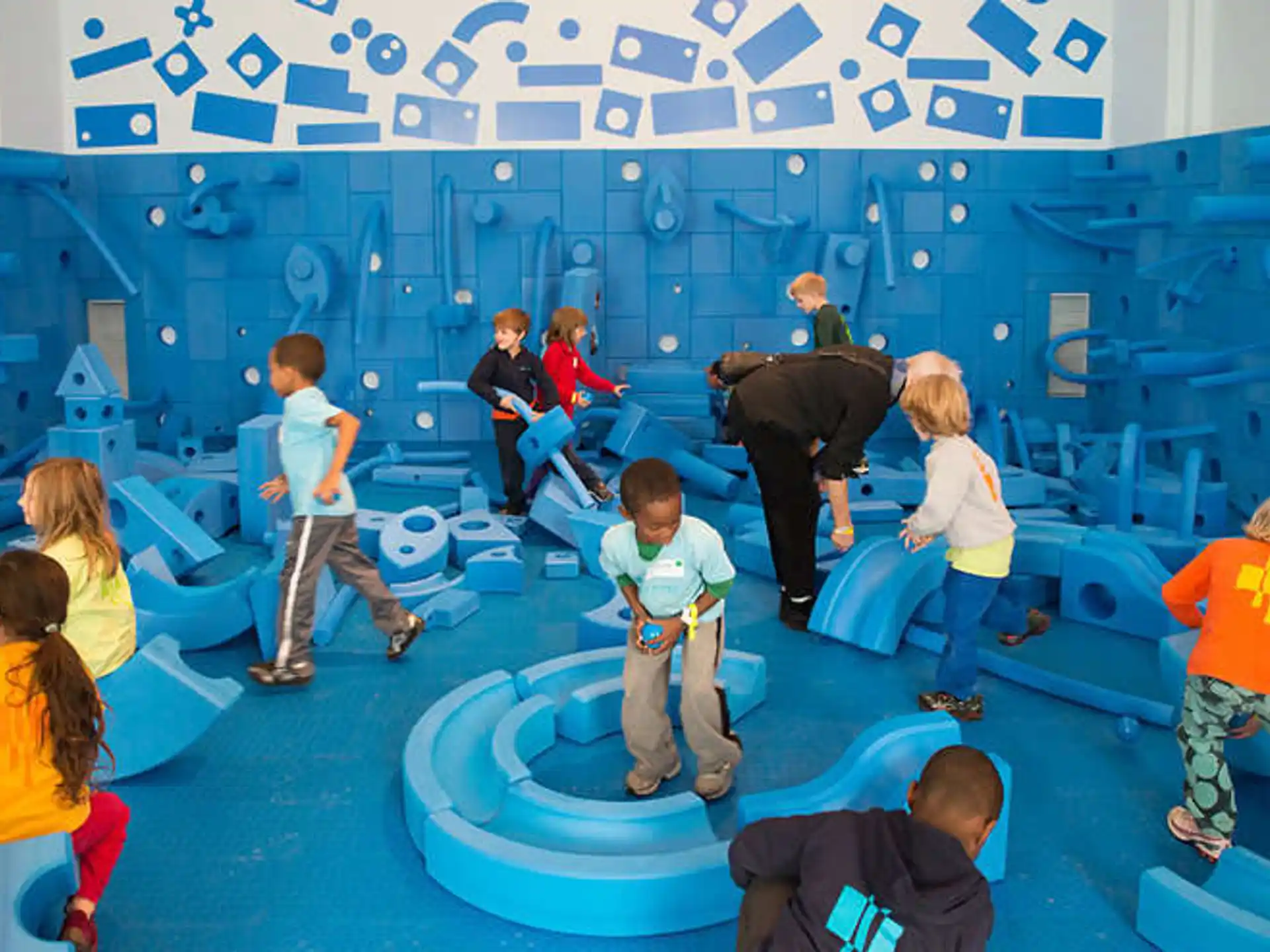 a group of people watching a person play a piano
