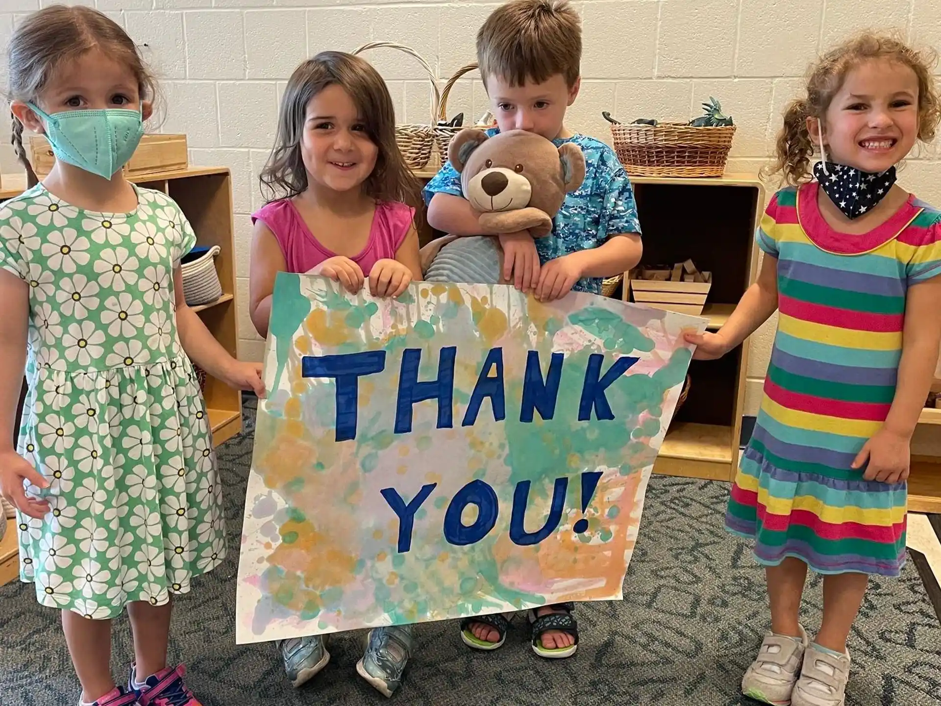 a group of children holding a sign