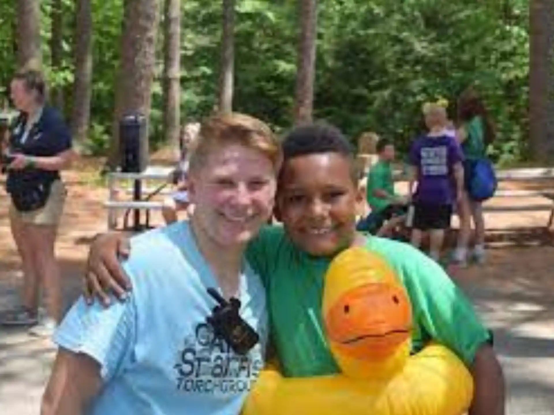 a person and a boy posing with a yellow duck