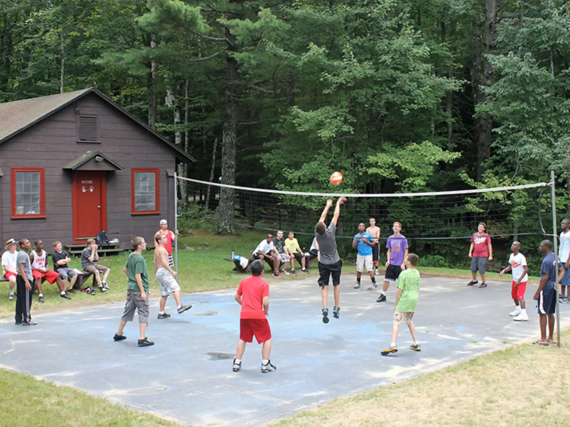a group of people playing volleyball