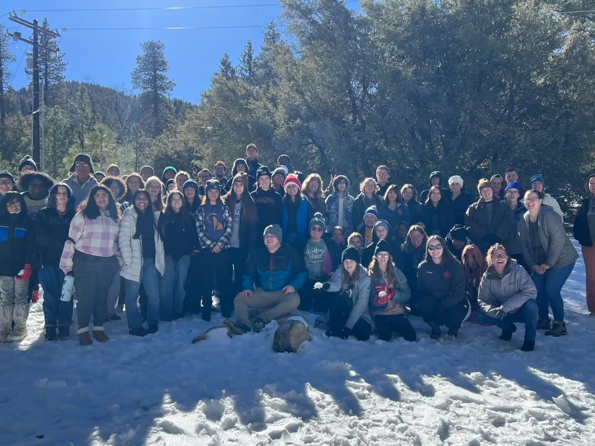 a group of people posing for a photo in the snow