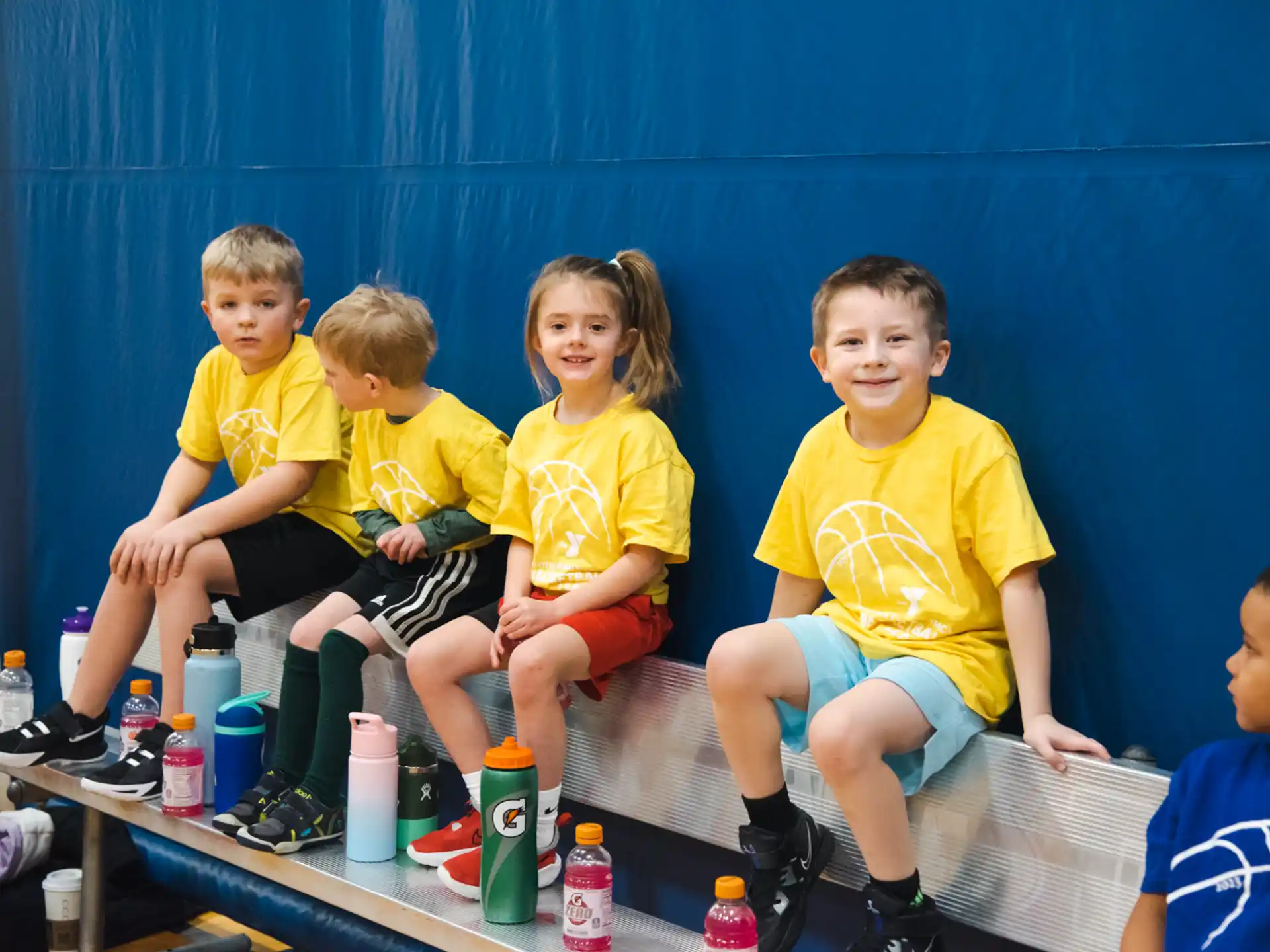 a group of children sitting on a bench