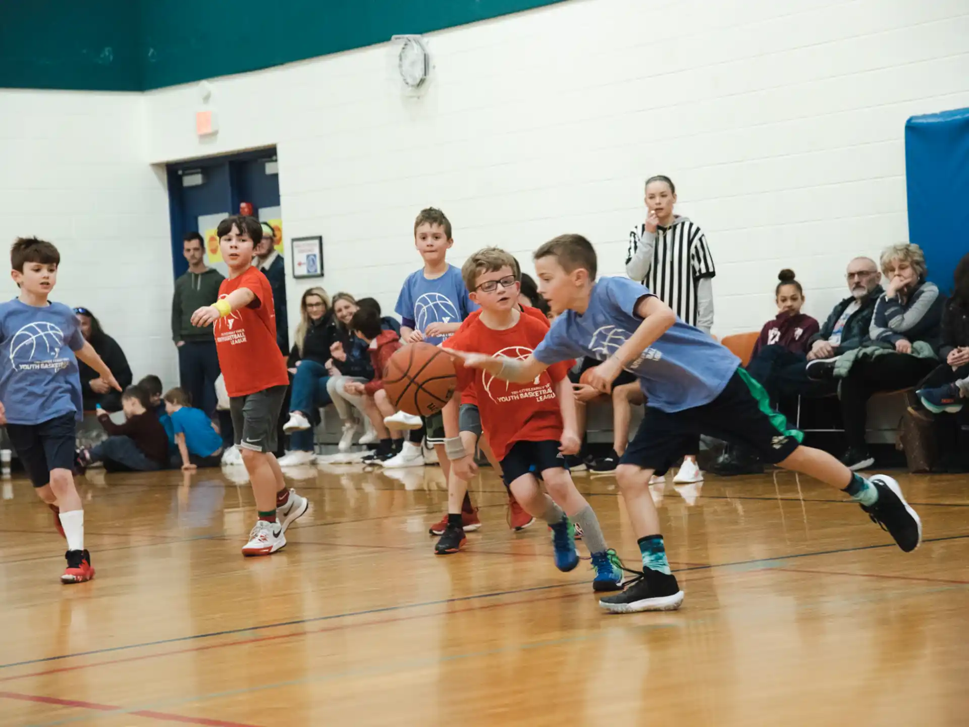 a group of kids playing basketball