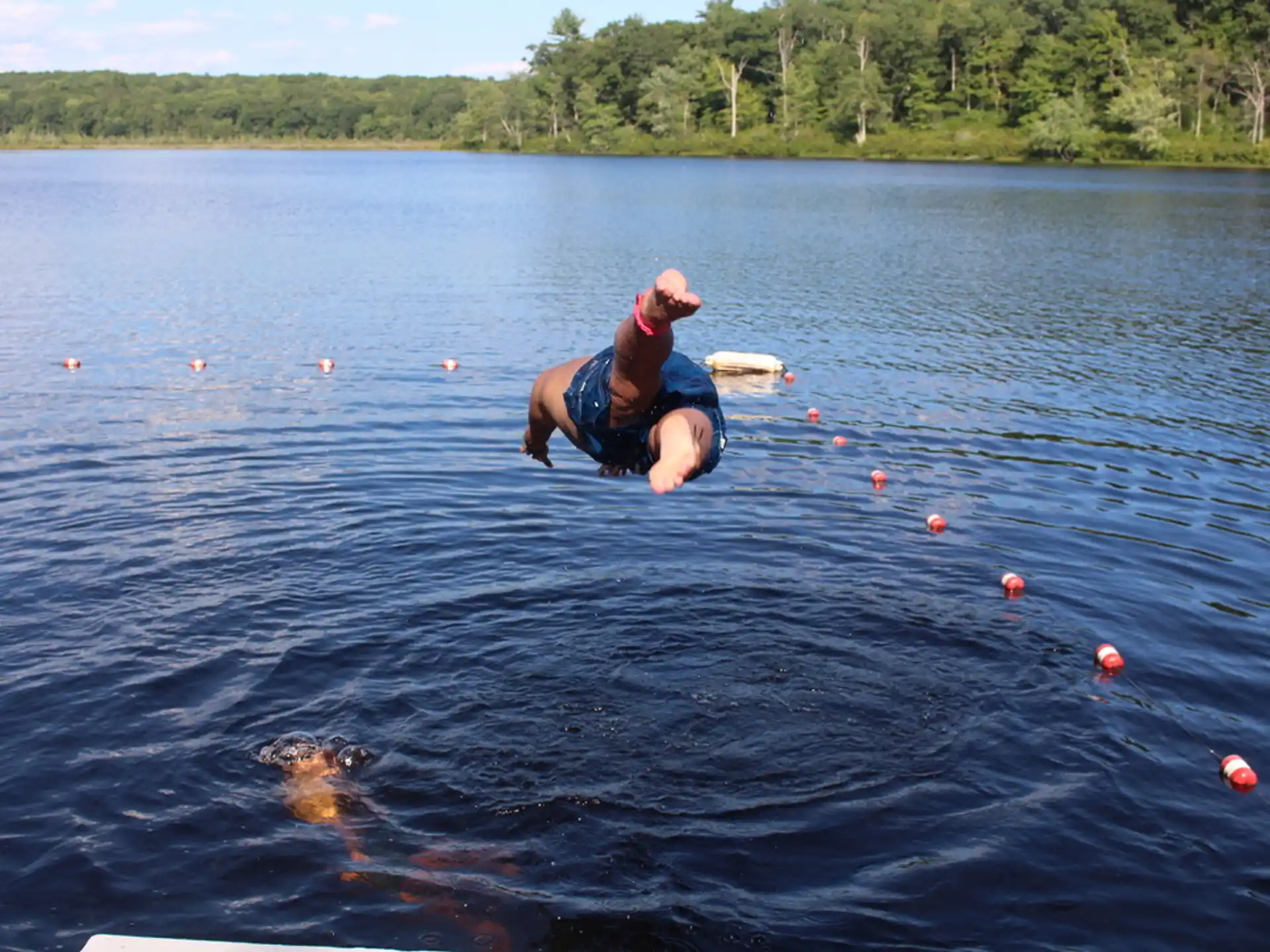 a man in the water with a fish in his hand