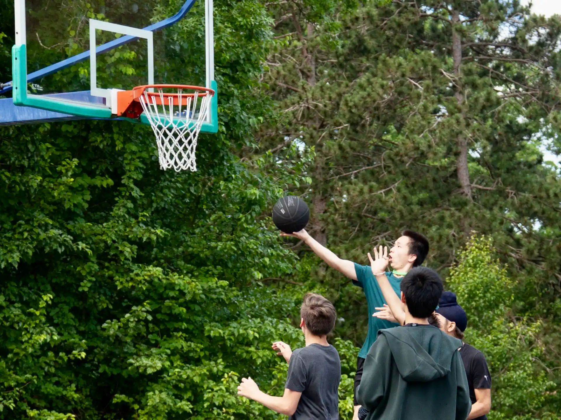 a group of people playing basketball