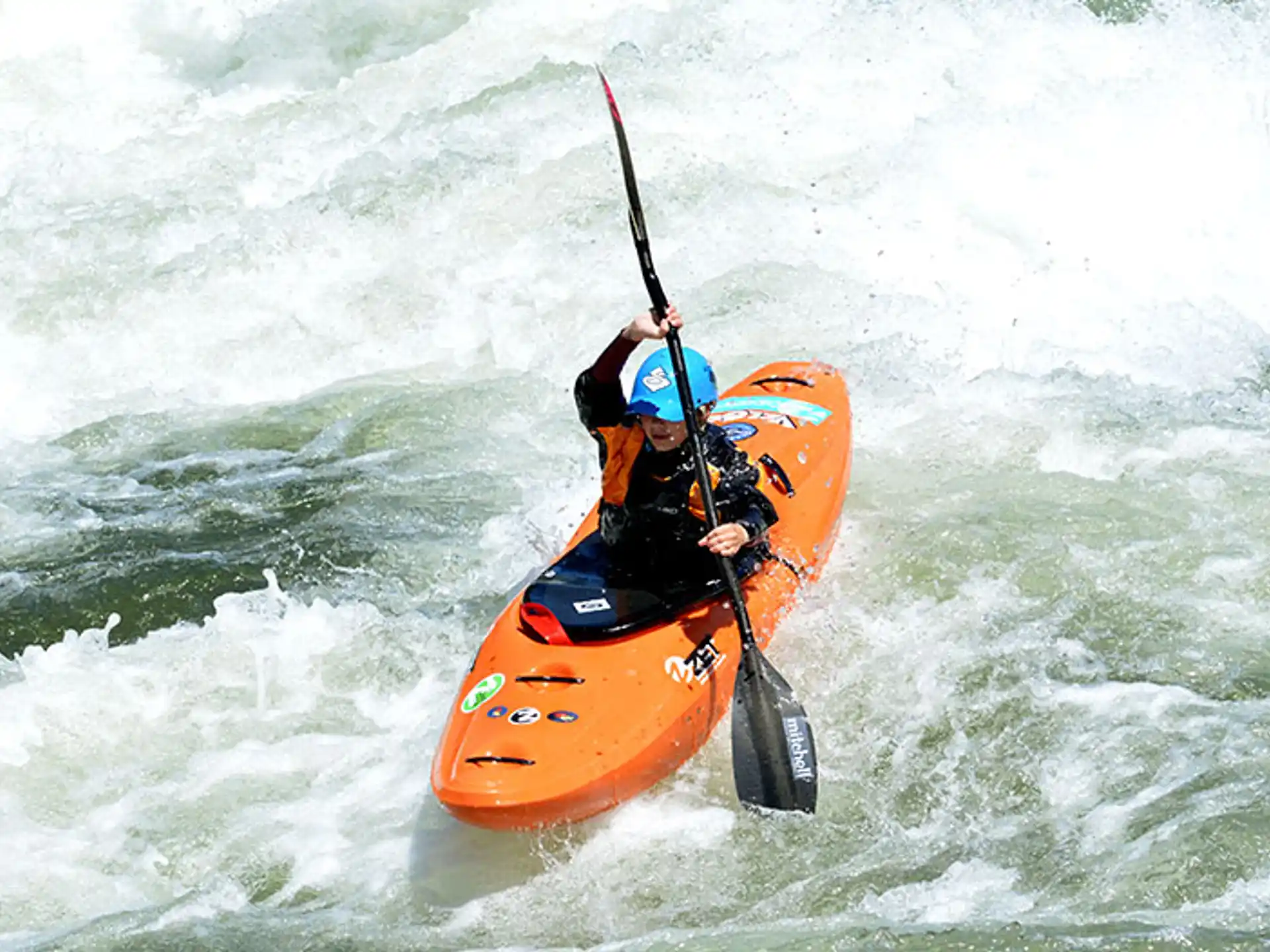 a person in a kayak in a river
