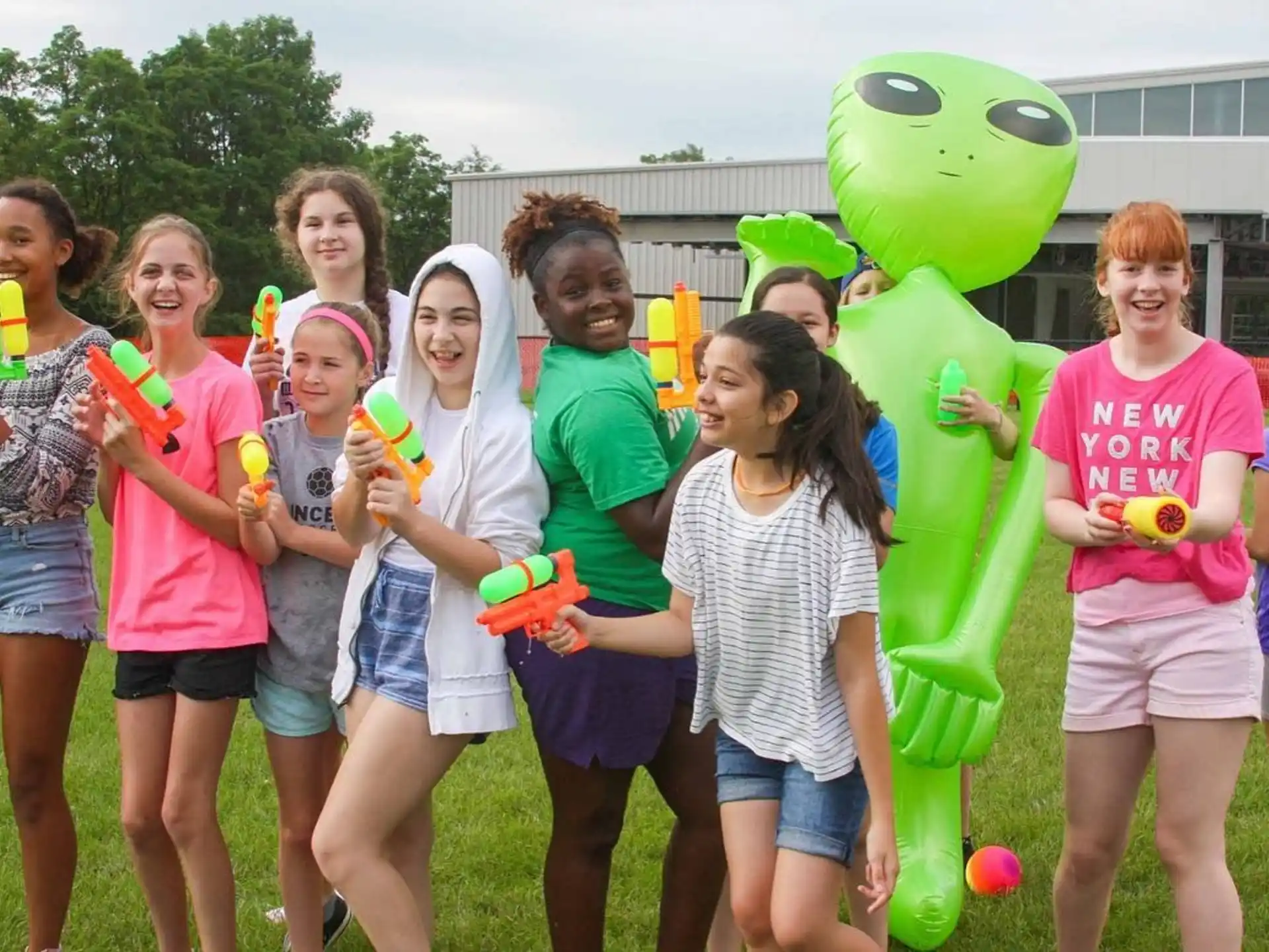 a group of girls holding balloons