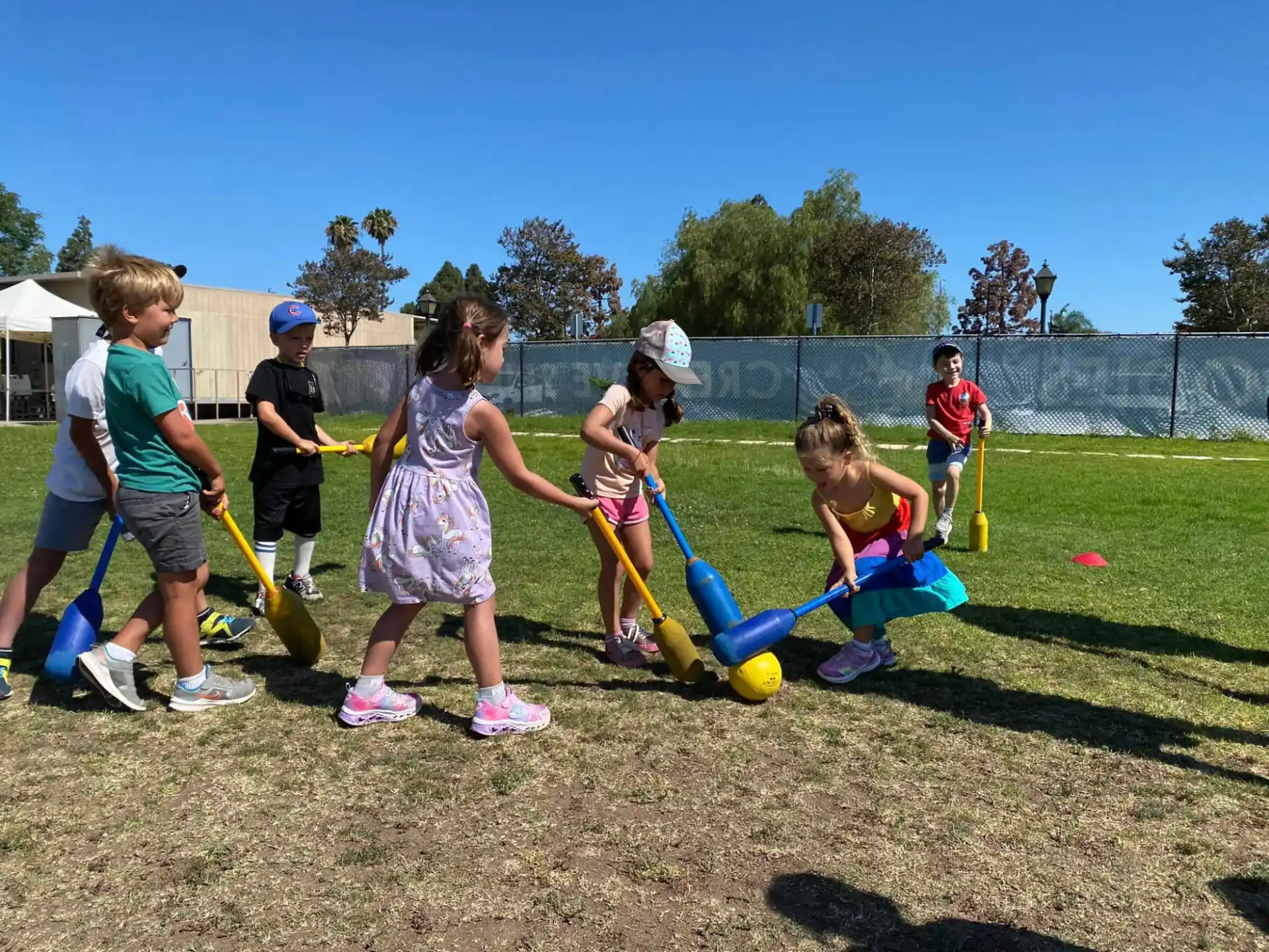 a group of children playing with a ball on a field