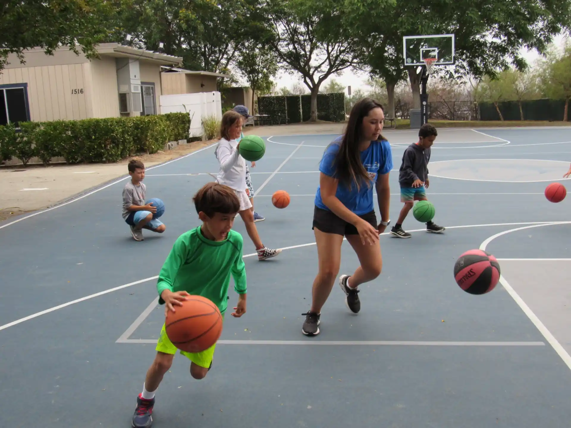a group of kids playing basketball