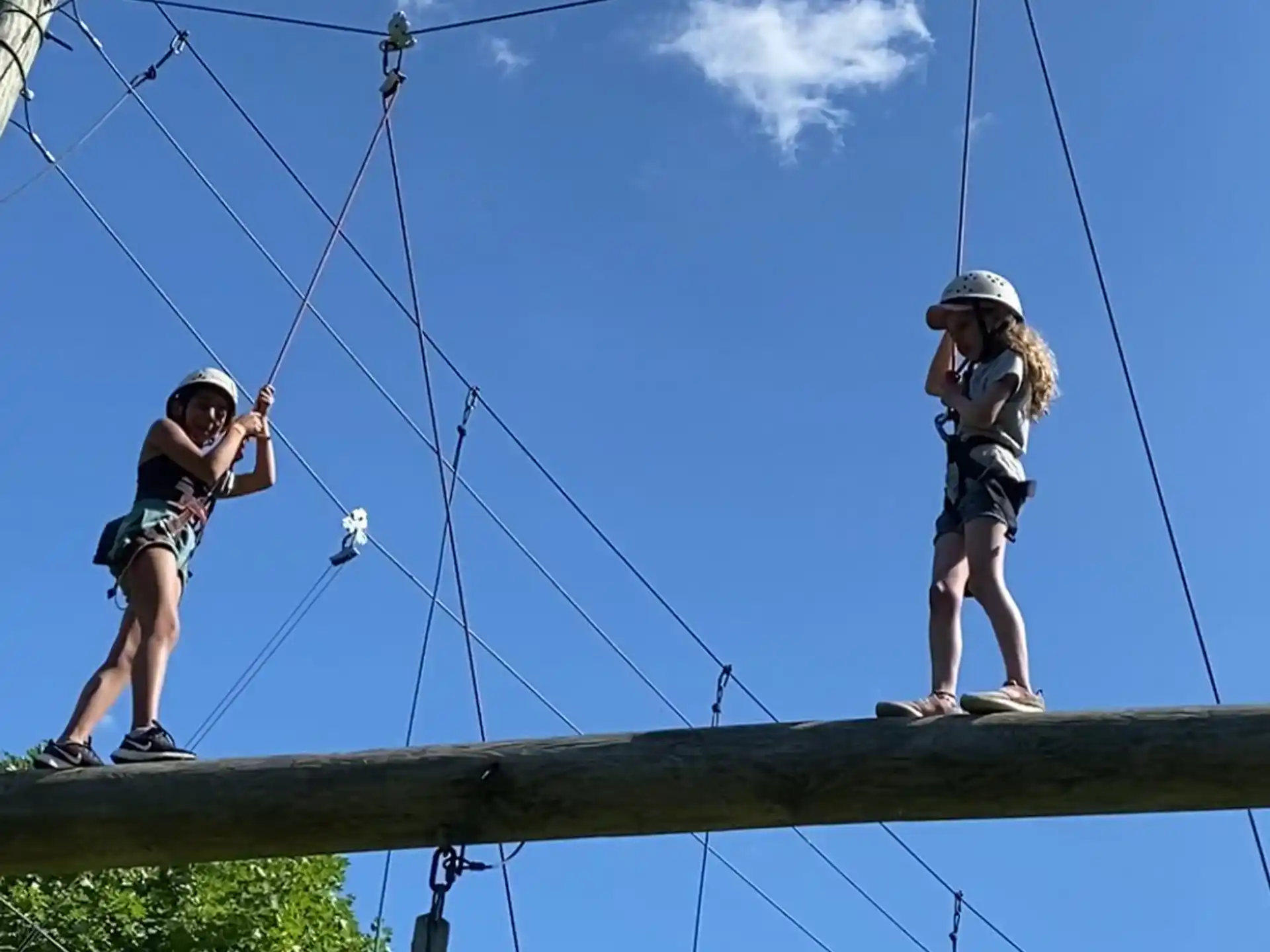 a couple of women on a wooden bridge