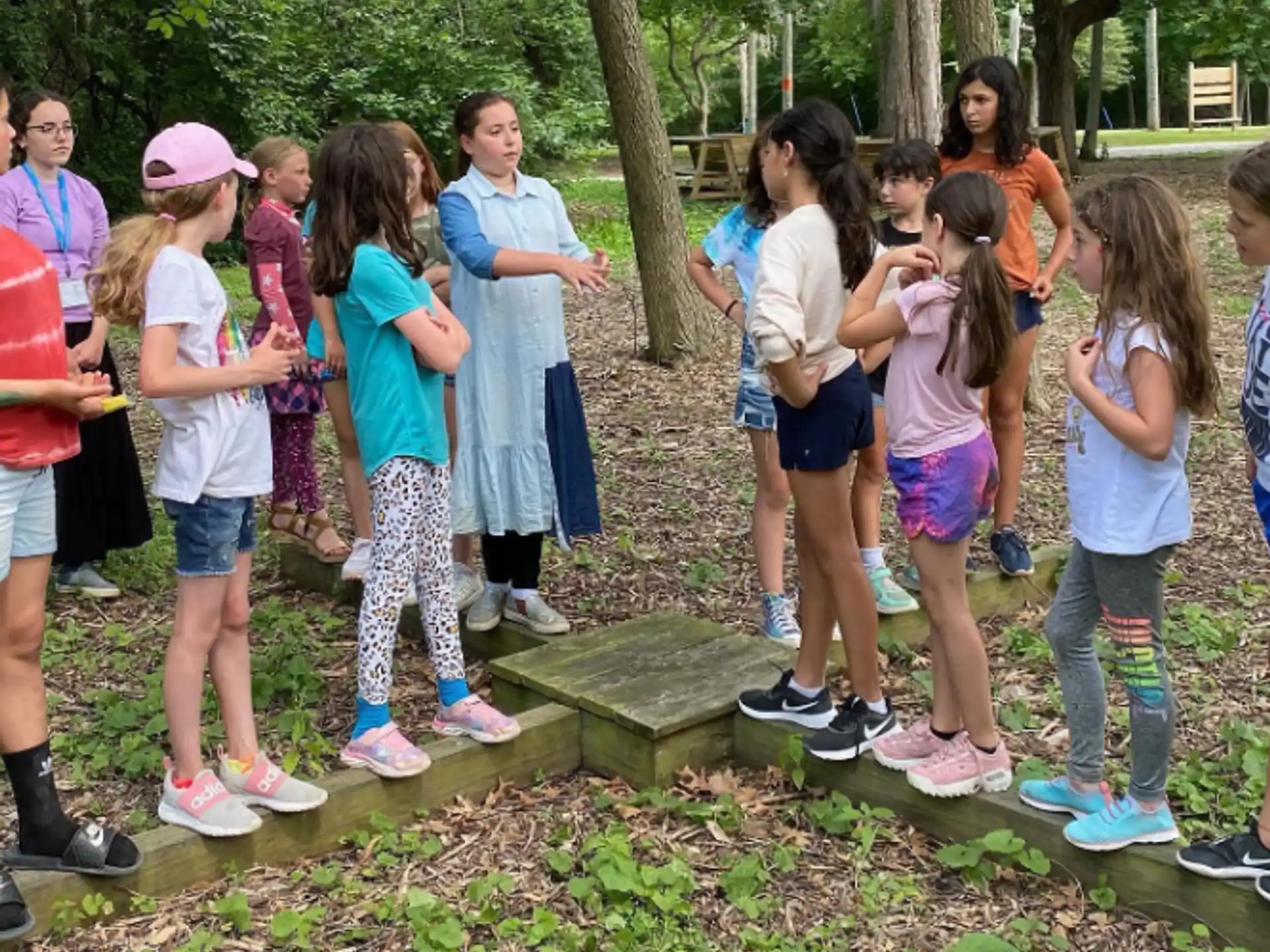 a group of children standing around a tree