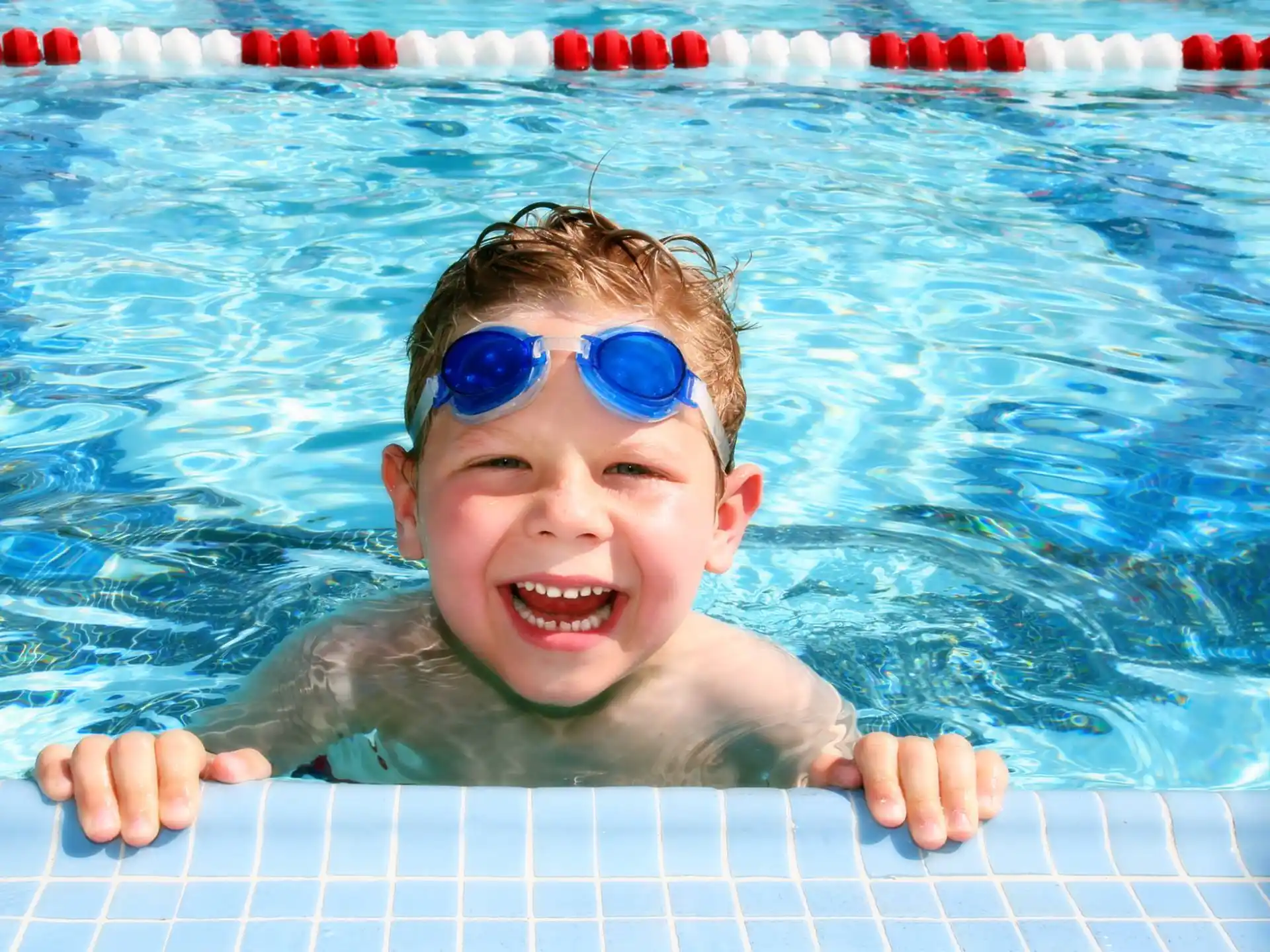 a baby in a pool wearing goggles