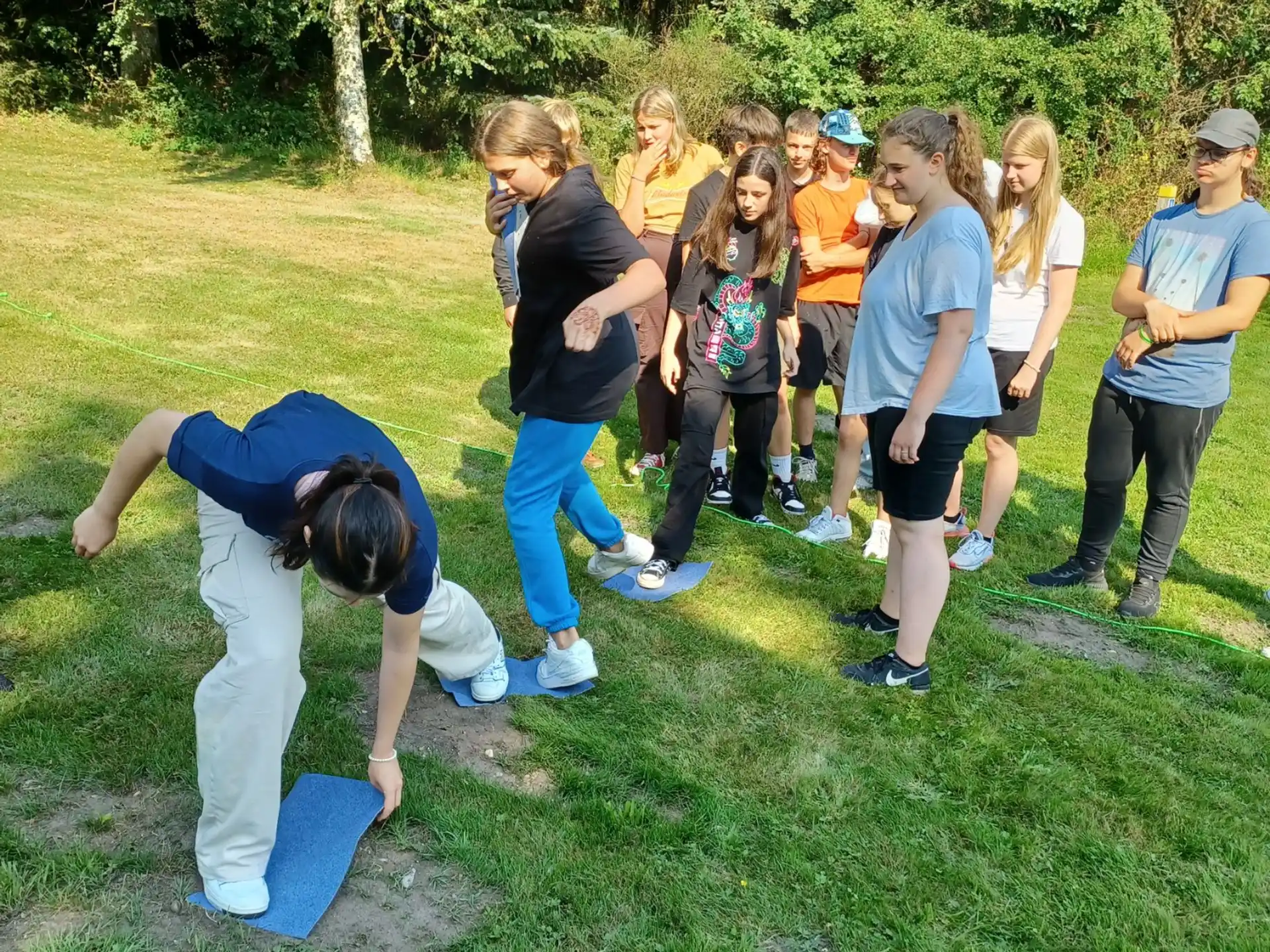 a group of people standing on grass
